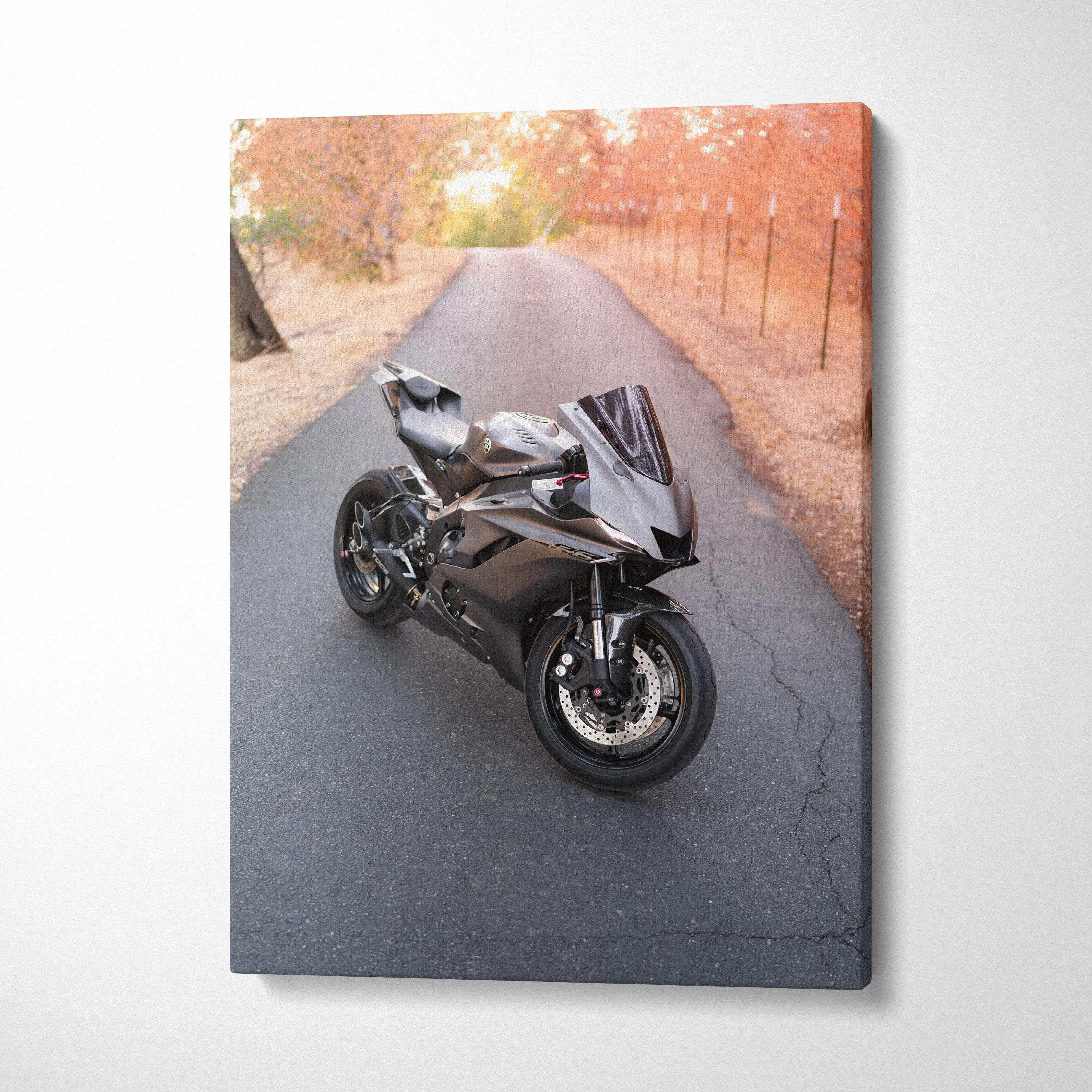 Vertical canvas art featuring a sleek black Yamaha R6 motorcycle on a tree-lined road with autumn leaves.