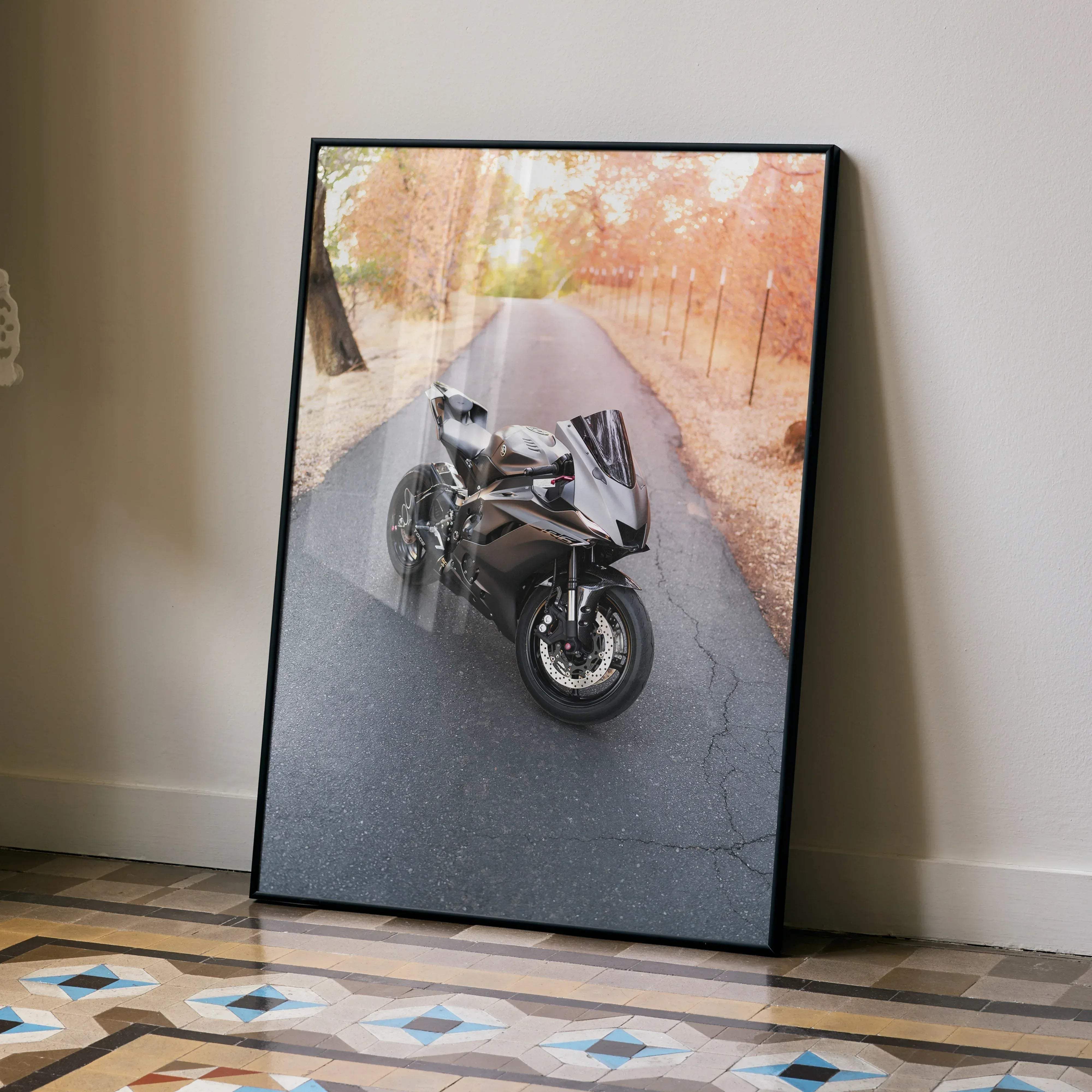 Black-framed yamaha r6 motorcycle poster showing a sleek dark sportbike on an asphalt road with autumn trees