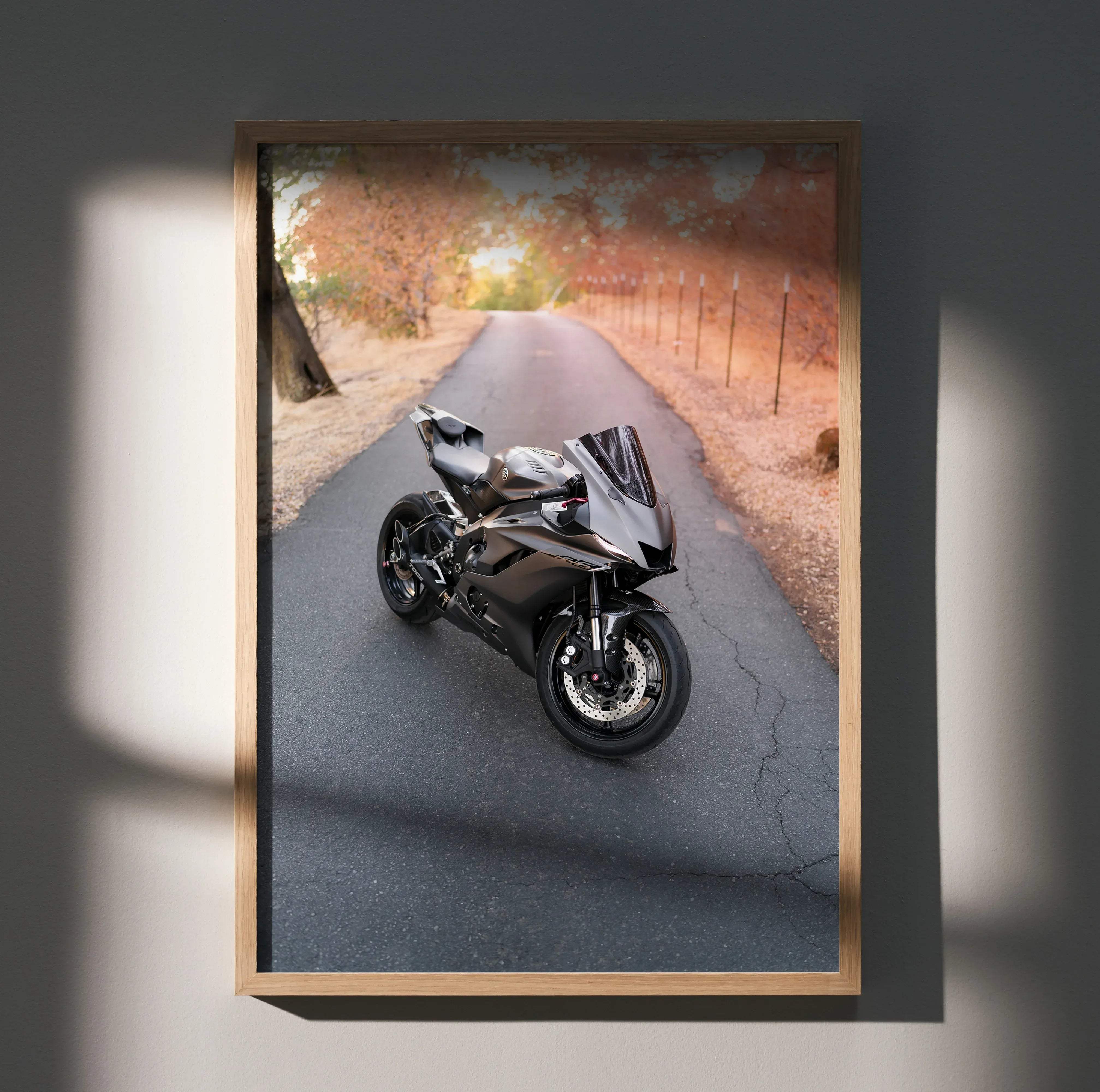 A sleek matte black Yamaha R6 sport motorcycle with glossy finish and aerodynamic design in motion on asphalt road