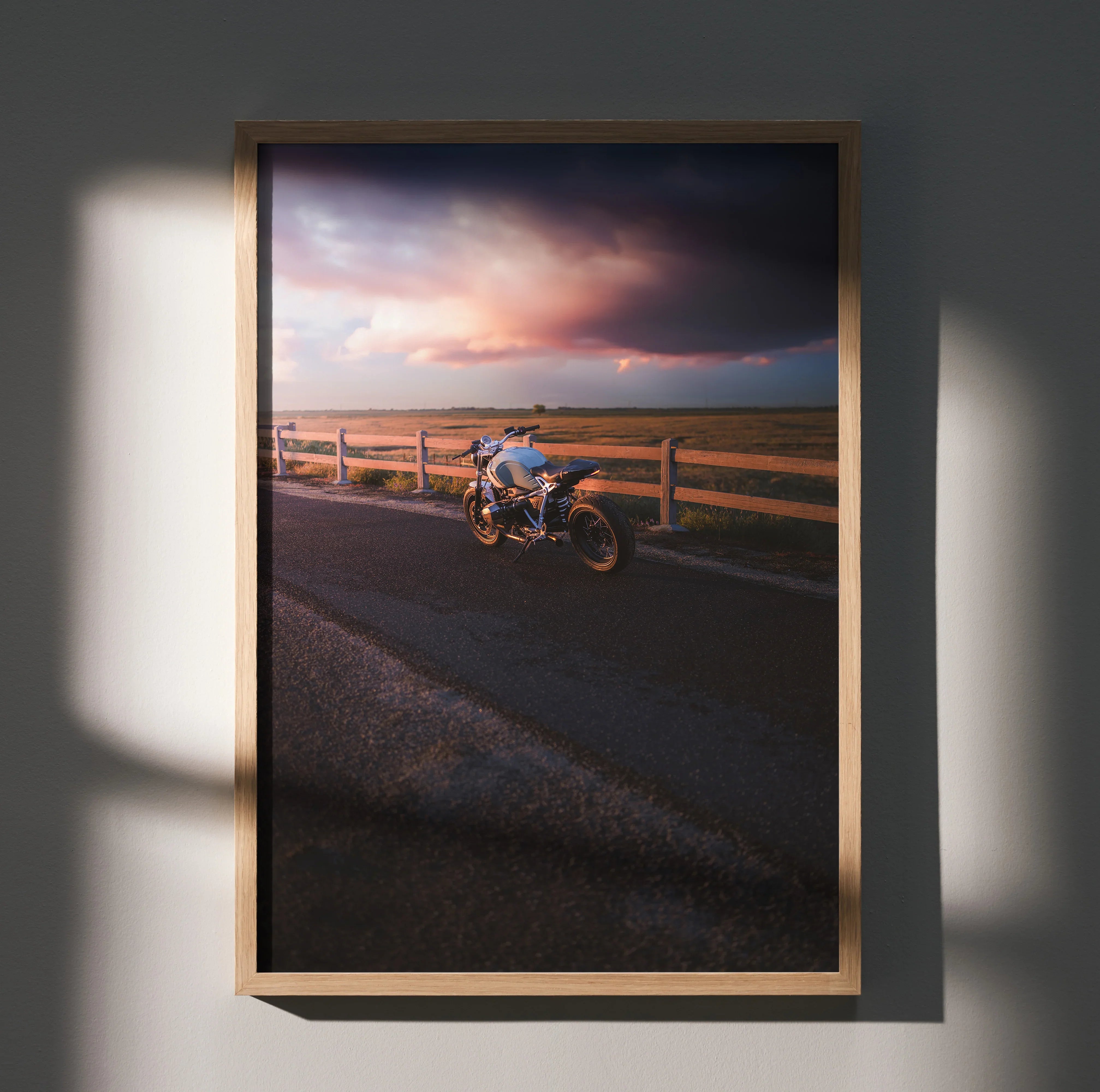 BMW R Nine T motorcycle parked near wooden fence at sunset poster wall art in wooden frame.