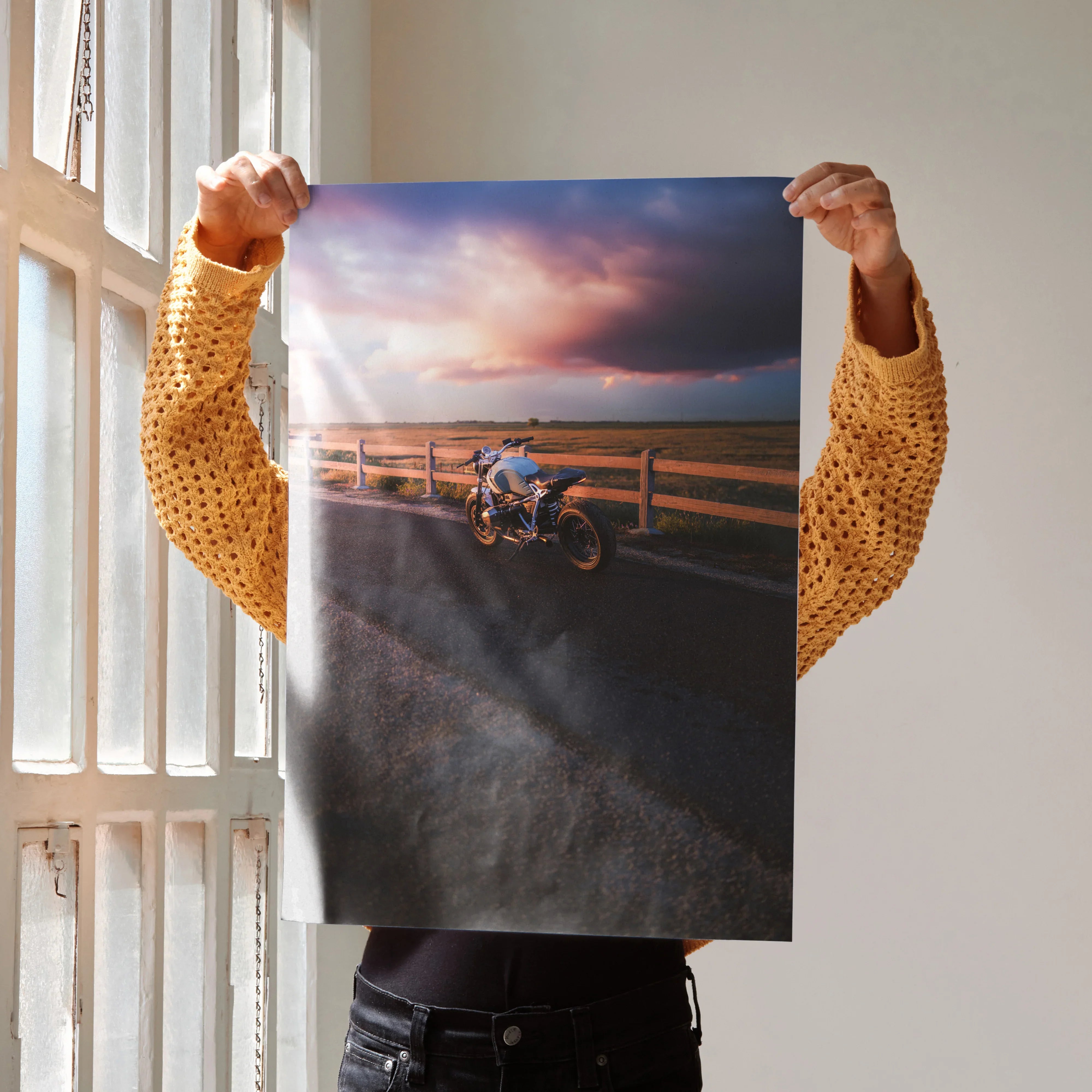 BMW R Nine T motorcycle parked by wooden fence at sunset poster wall art with dramatic sky.