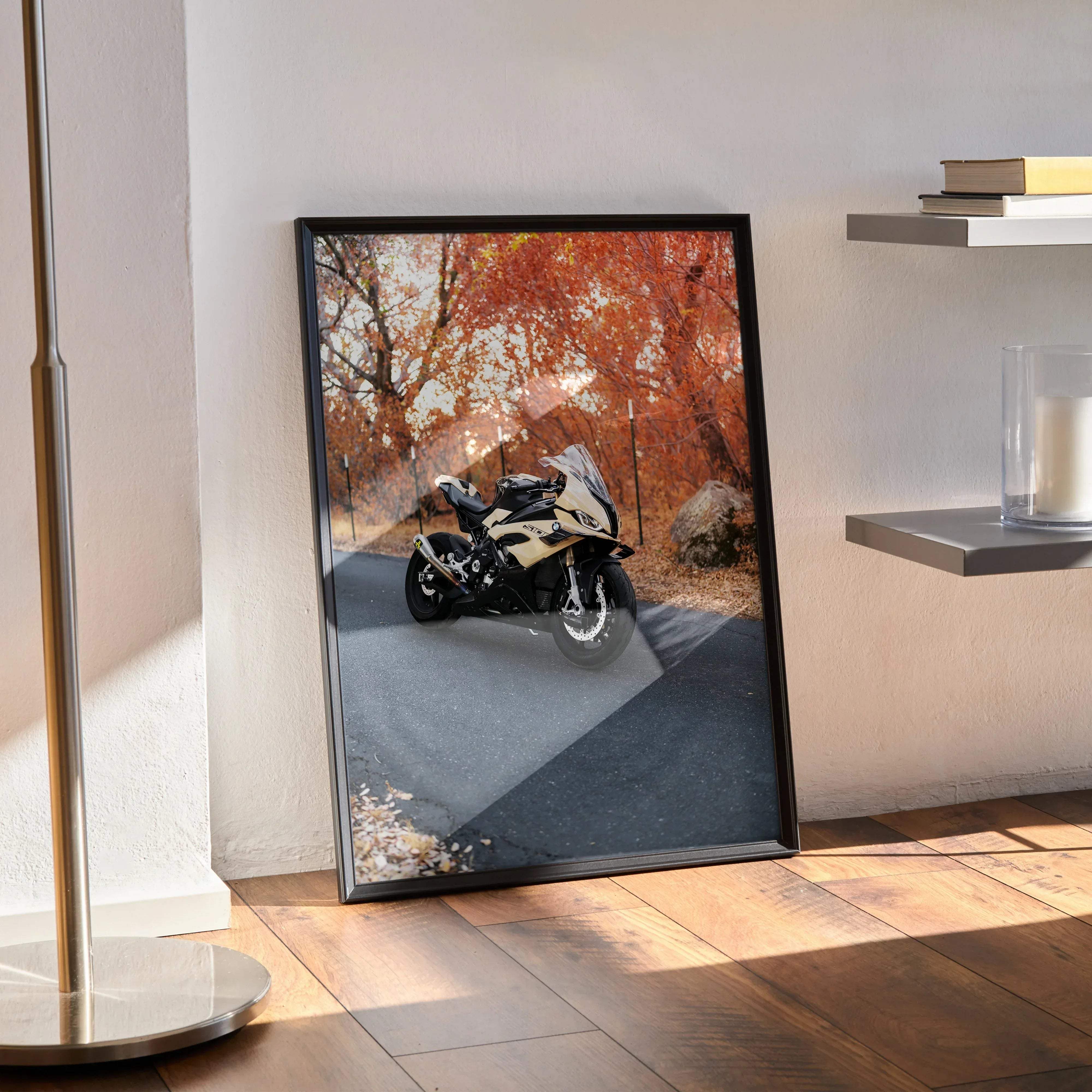 Black-framed poster of a cream and black bmw s1000rr motorcycle speeding on an autumn tree-lined road