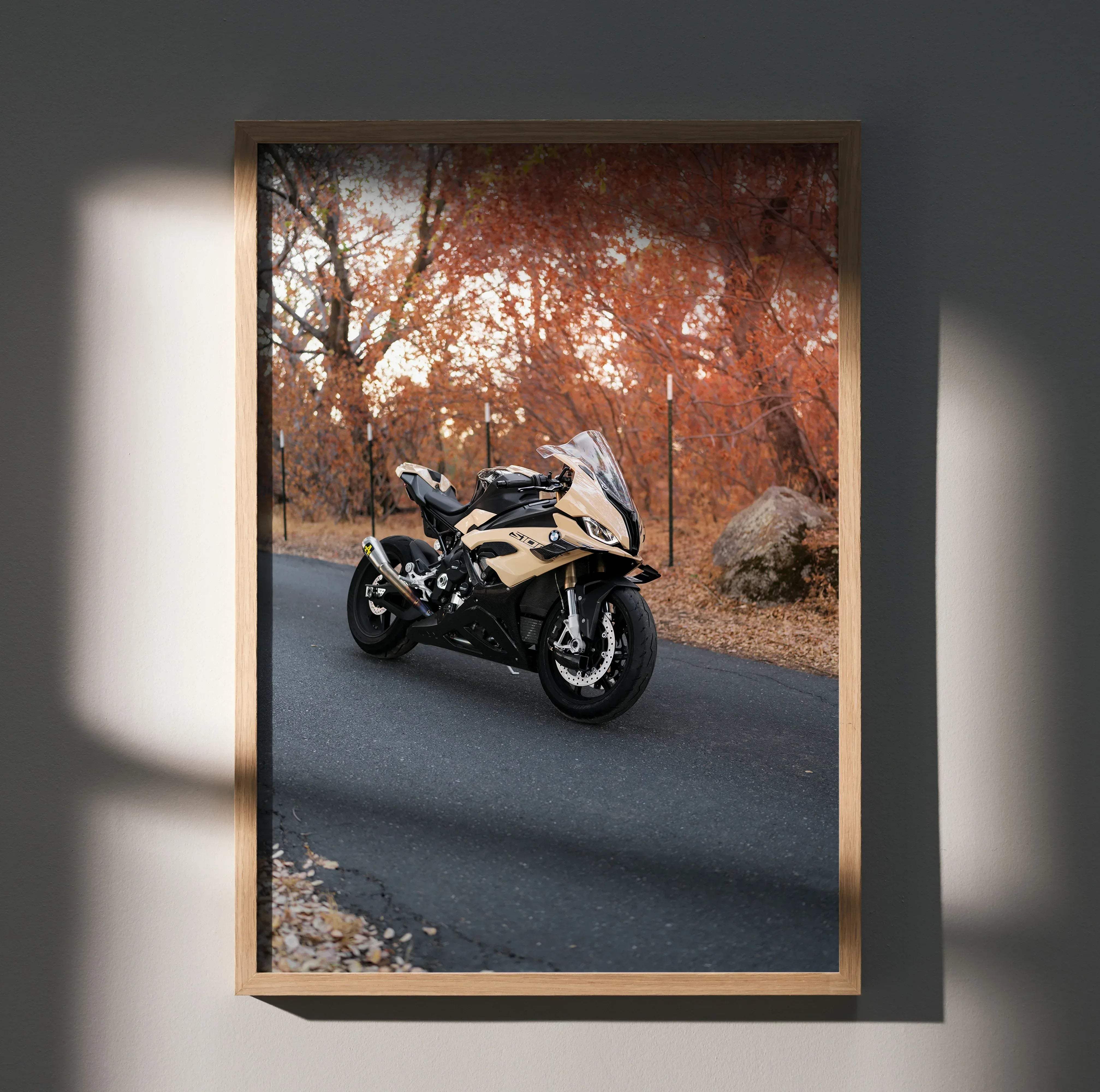 A framed high resolution poster of a beige and black BMW S1000RR motorcycle on an autumn road