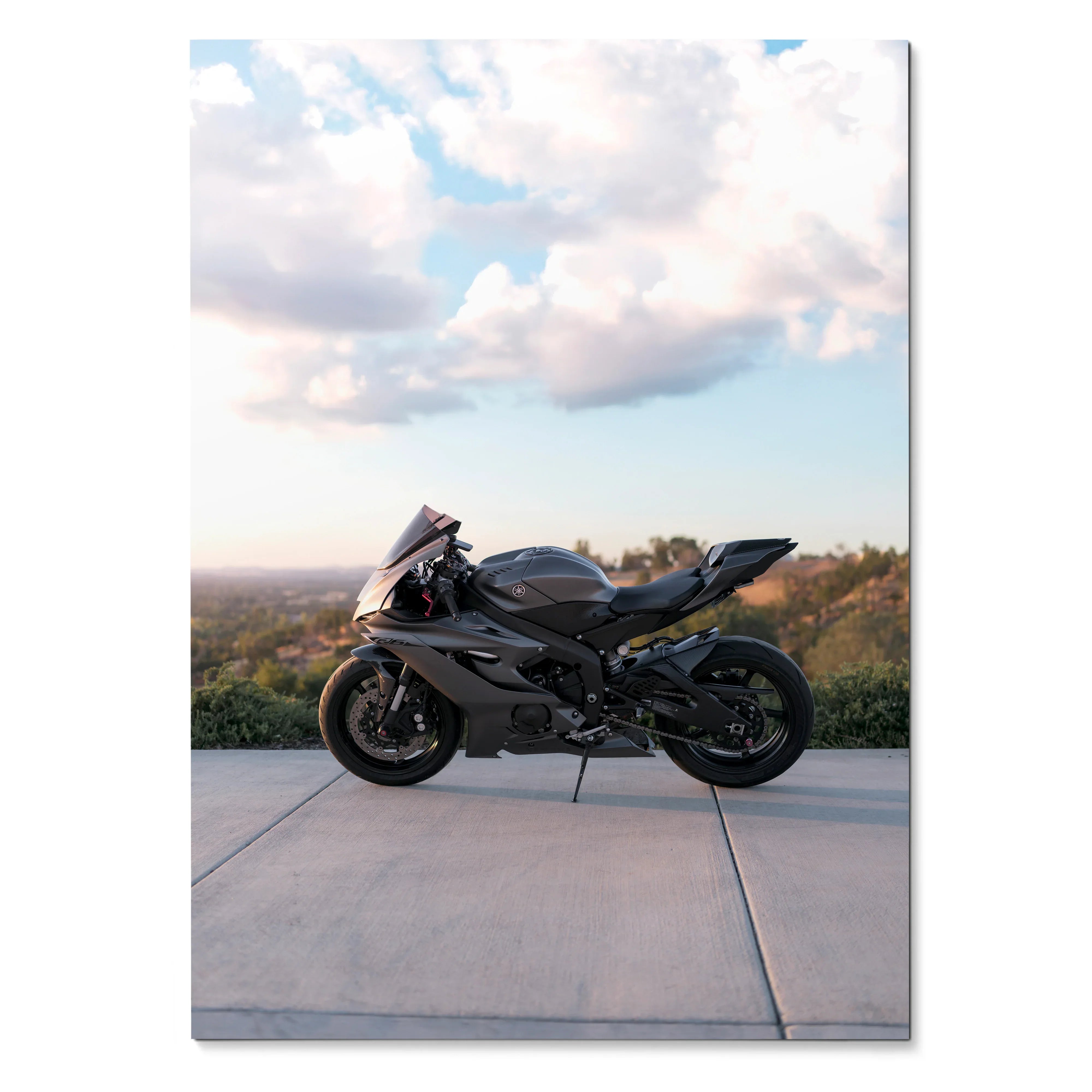 Yamaha R6 motorcycle parked on concrete with scenic sky background poster wall art.
