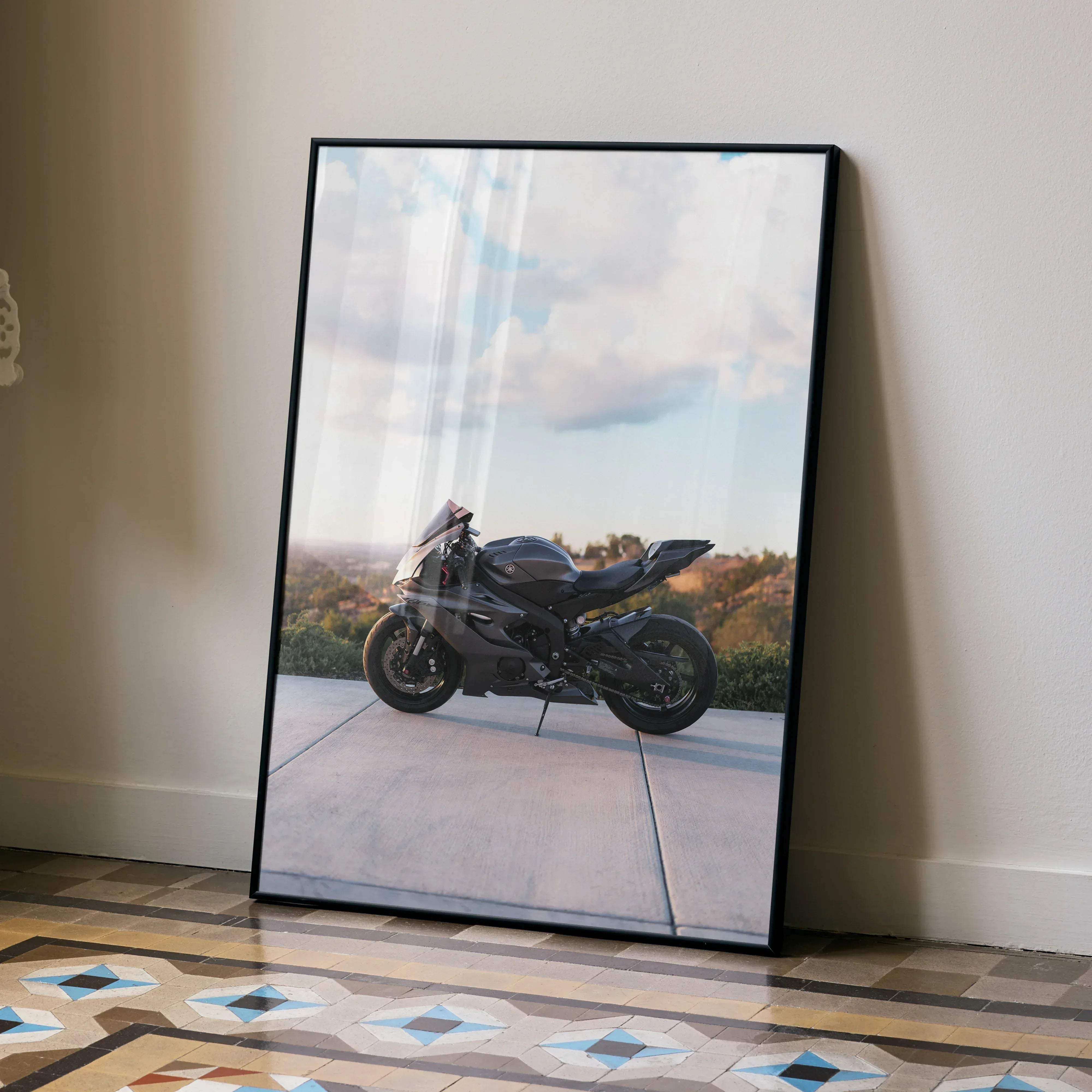 Black-framed poster featuring a sleek matte black Yamaha R6 sport motorcycle under a partly cloudy sky