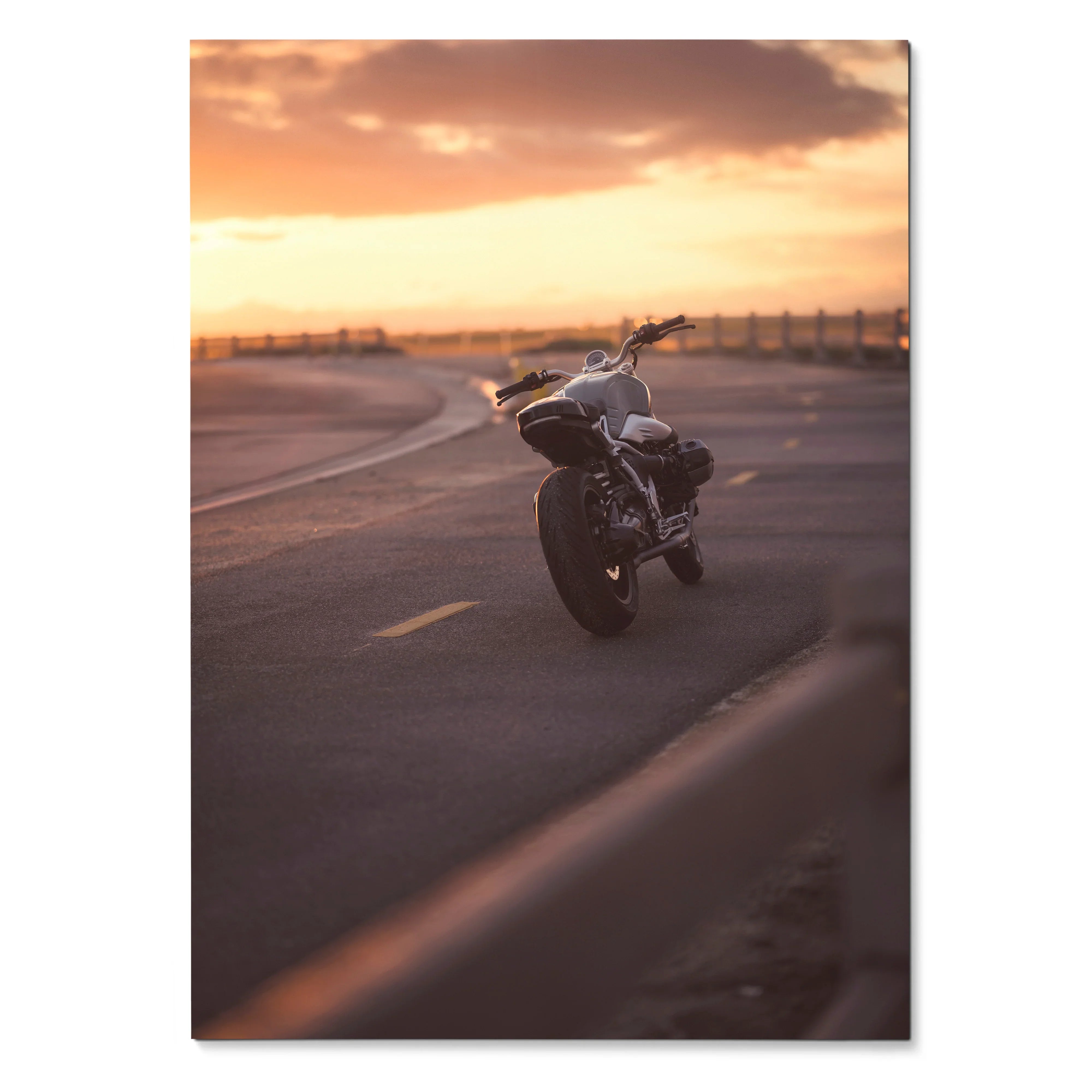 BMW R Nine T motorcycle on road at sunset Poster wall art with warm orange sky background.