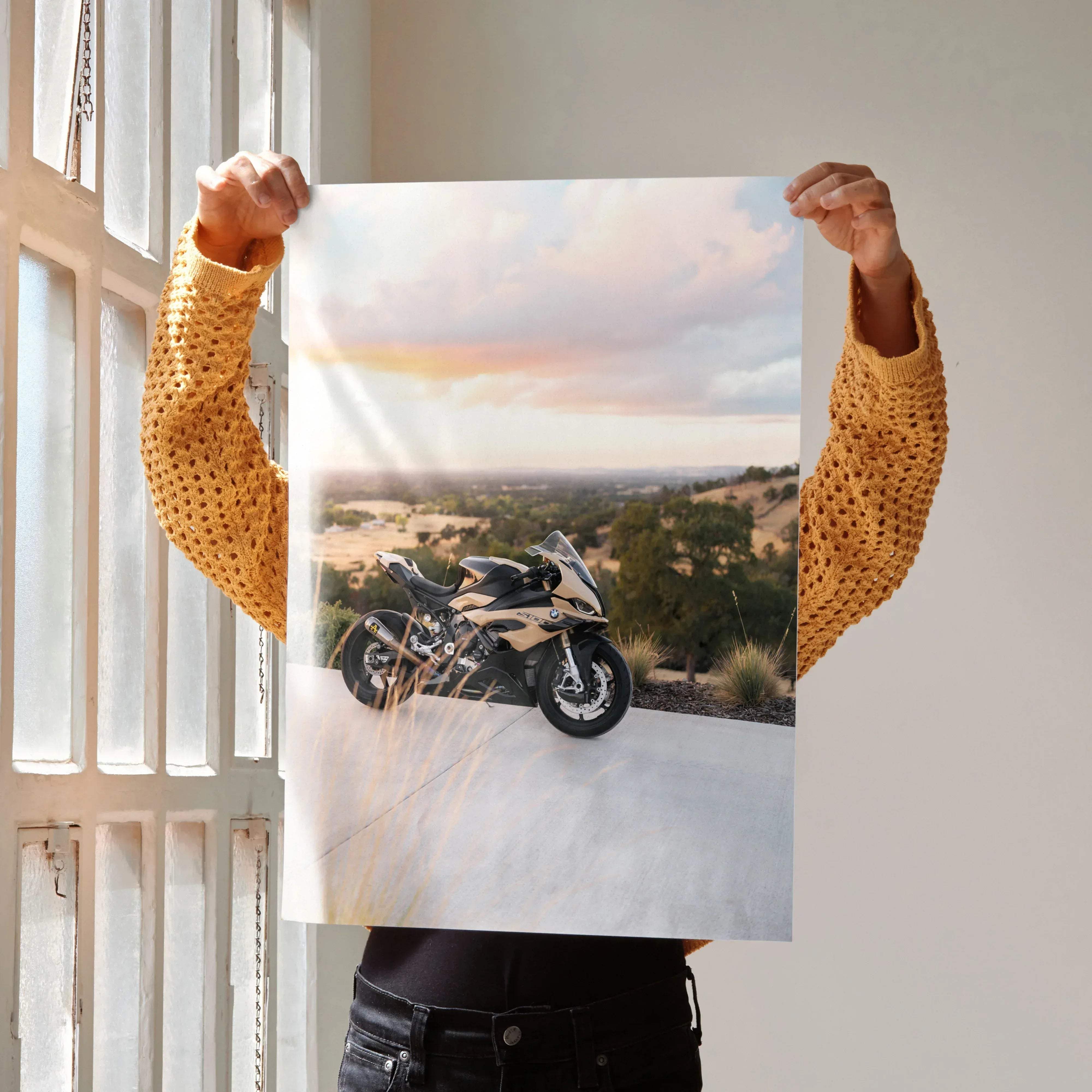 A sleek black and gold BMW inspired S1000RR motorcycle poster with a sporty bike against a sunset backdrop