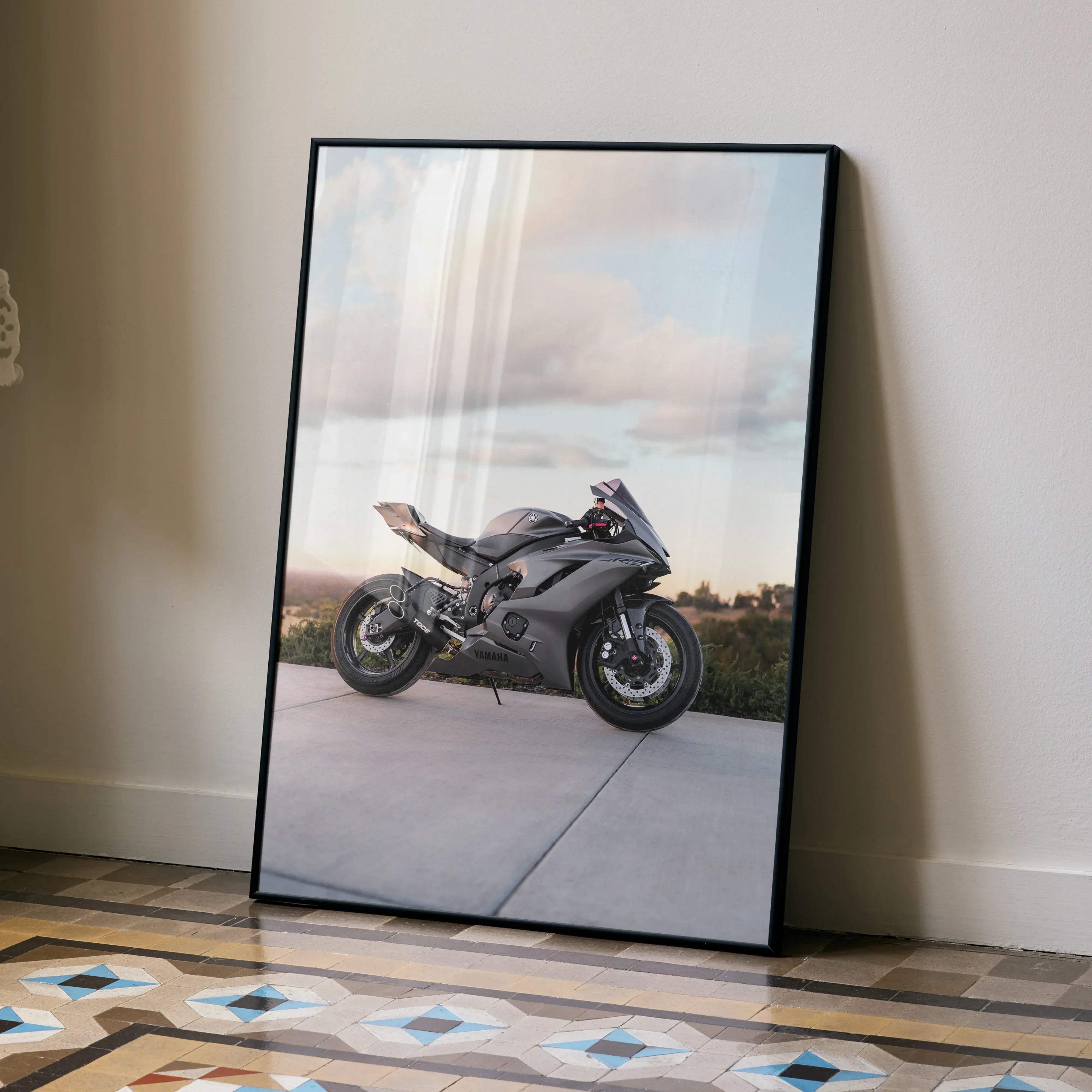 Black-framed poster featuring a sleek matte gray yamaha r6 motorcycle against a soft sky backdrop