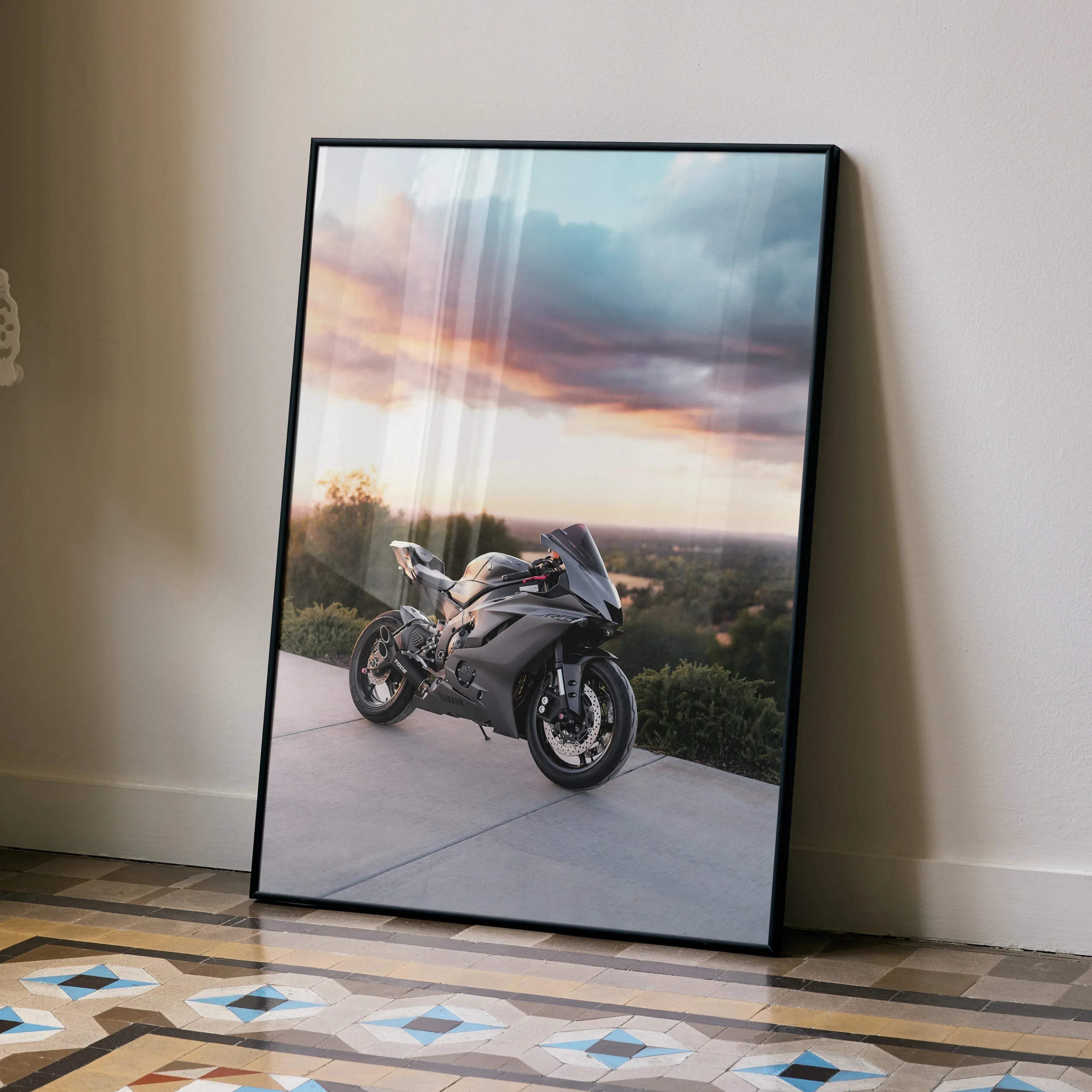 Black-framed poster of a sleek matte gray Yamaha R6 sport motorcycle under a dramatic sunset sky