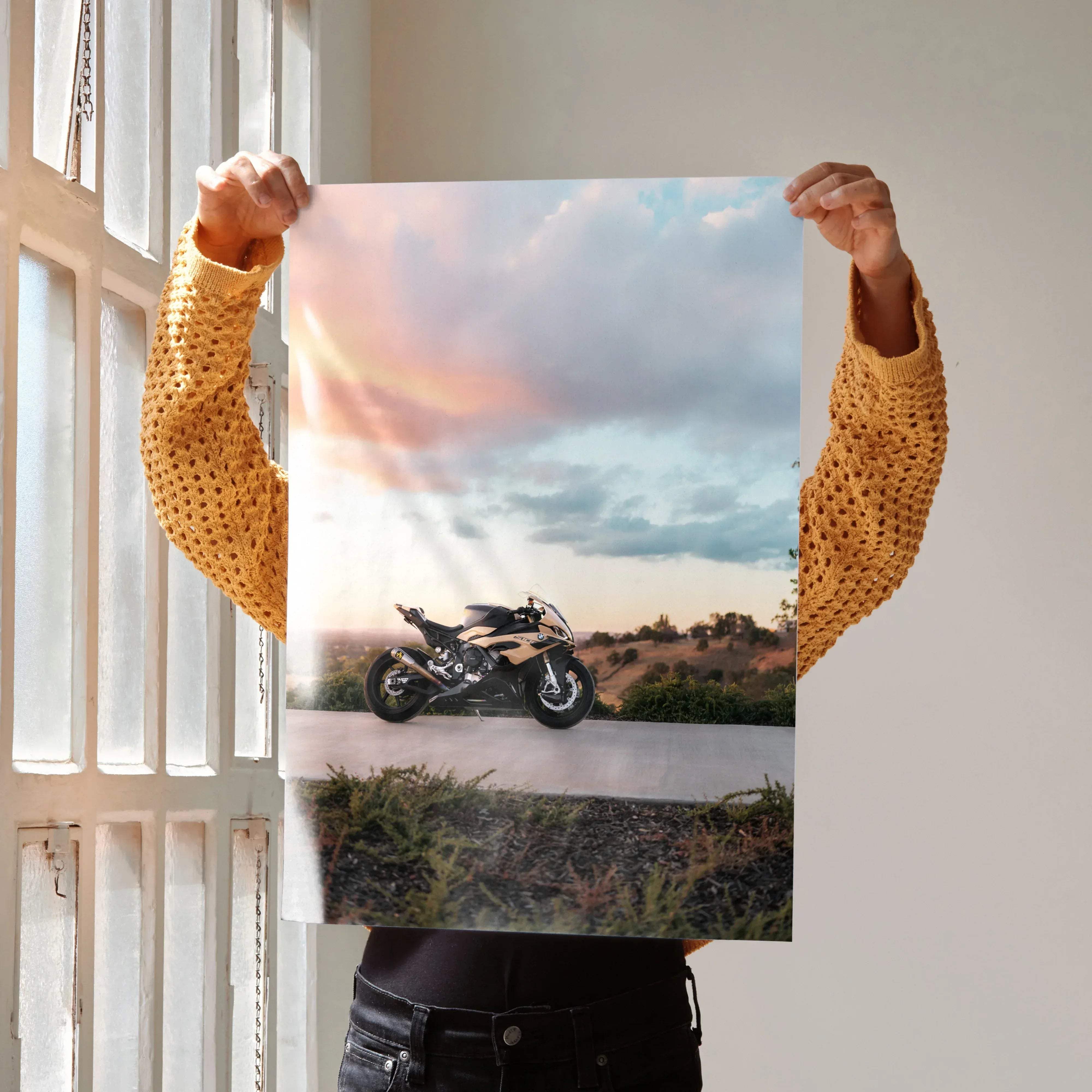 A sleek black and gold BMW inspired S1000RR motorcycle poster featuring a sporty bike under a sunset sky