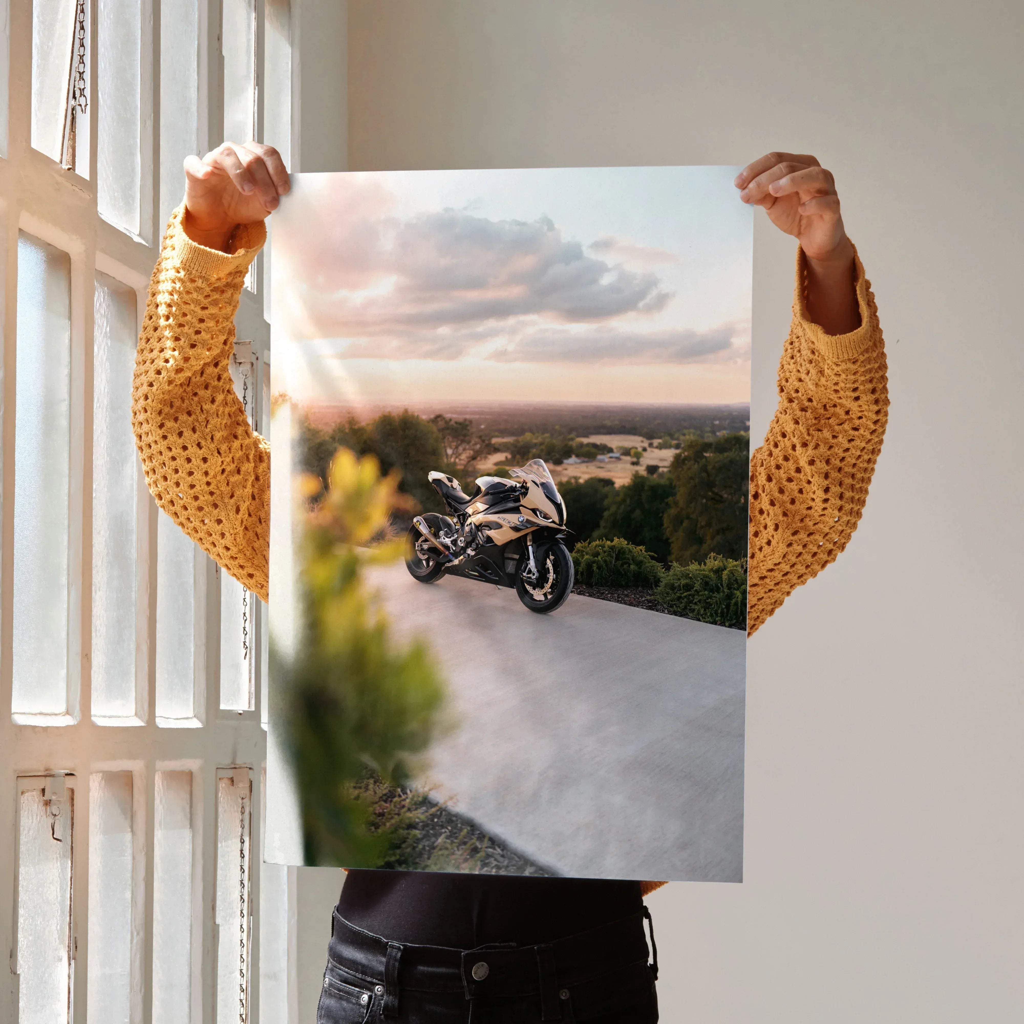 A sleek two-tone bmw inspired s1000rr motorcycle poster with black and metallic gold sportbike at sunset winding road