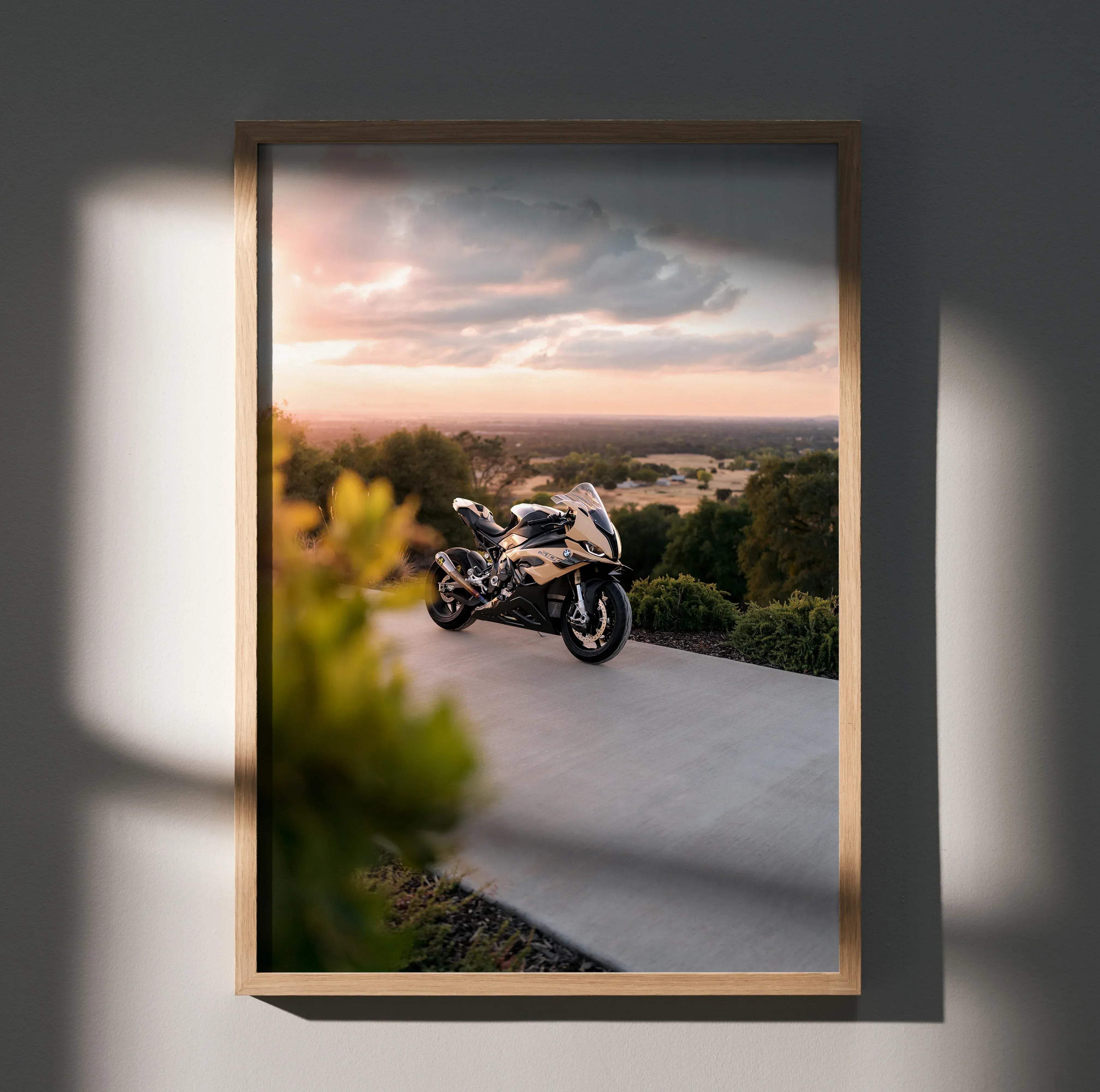 A sleek two-tone BMW inspired S1000RR motorcycle poster showing black and metallic gold bike against sunset sky