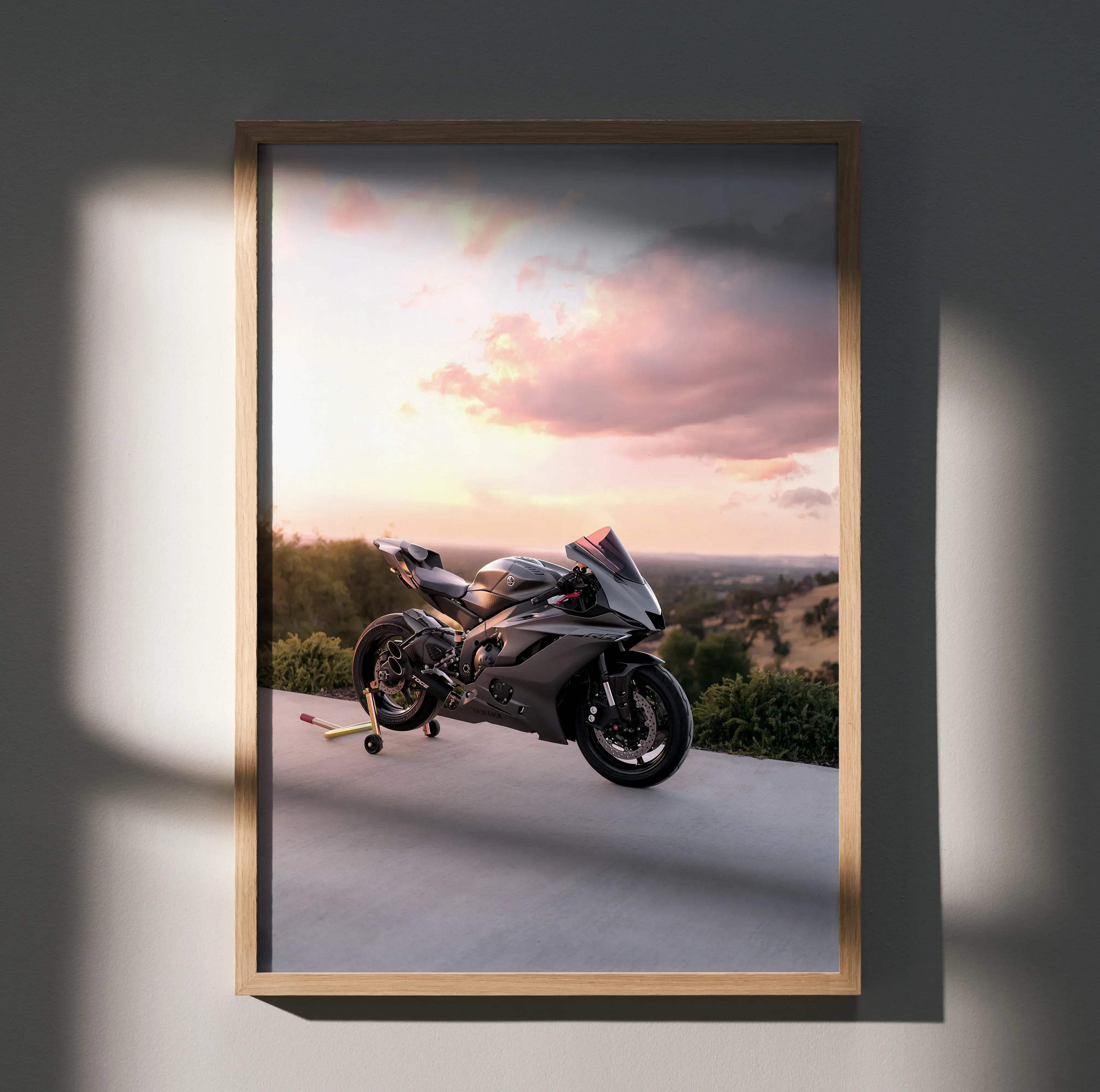 A sleek matte black and silver yamaha r6 motorcycle with aerodynamic fairings in a framed print poster