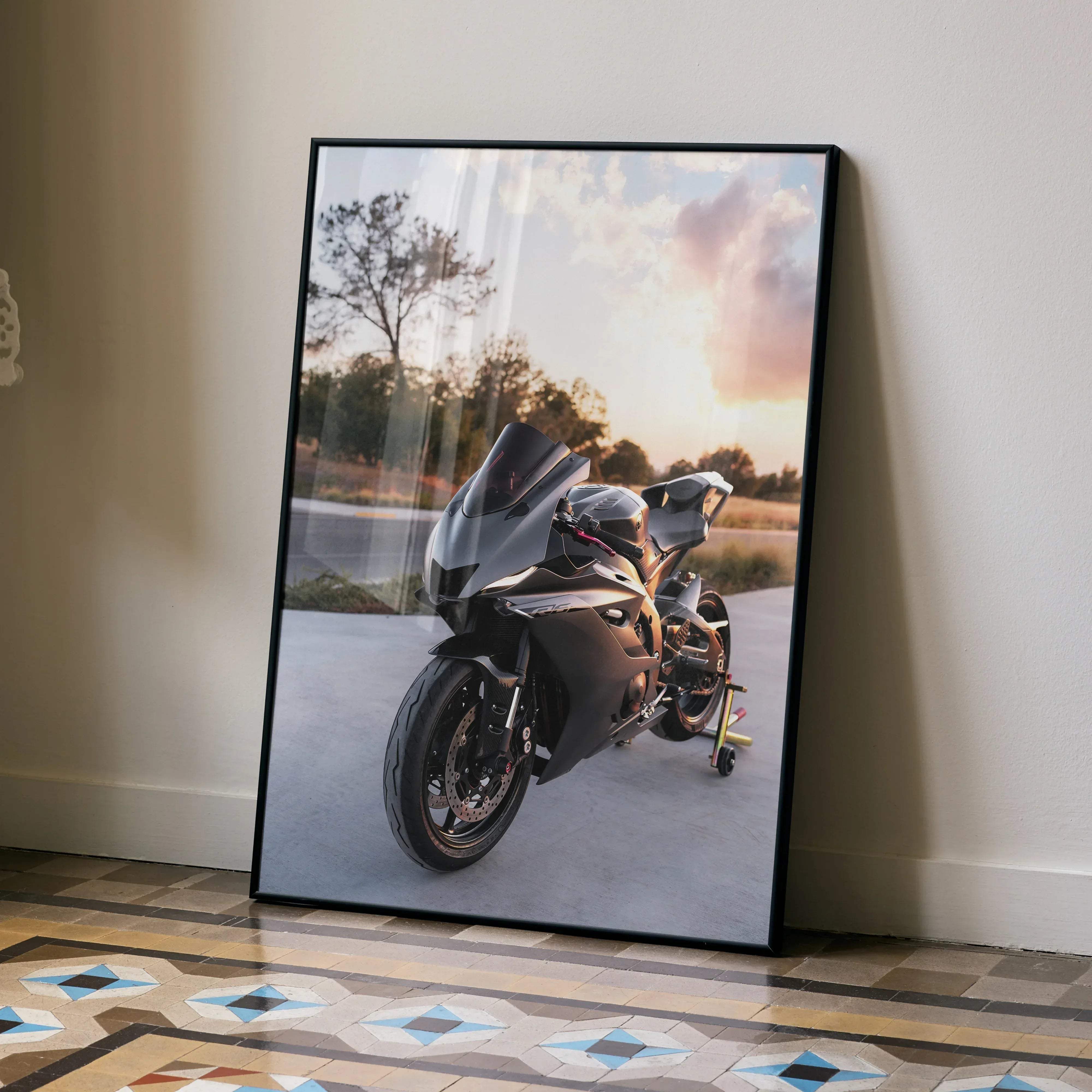 Black-framed poster featuring a sleek matte black Yamaha R6 sport motorcycle under a warm sunset sky