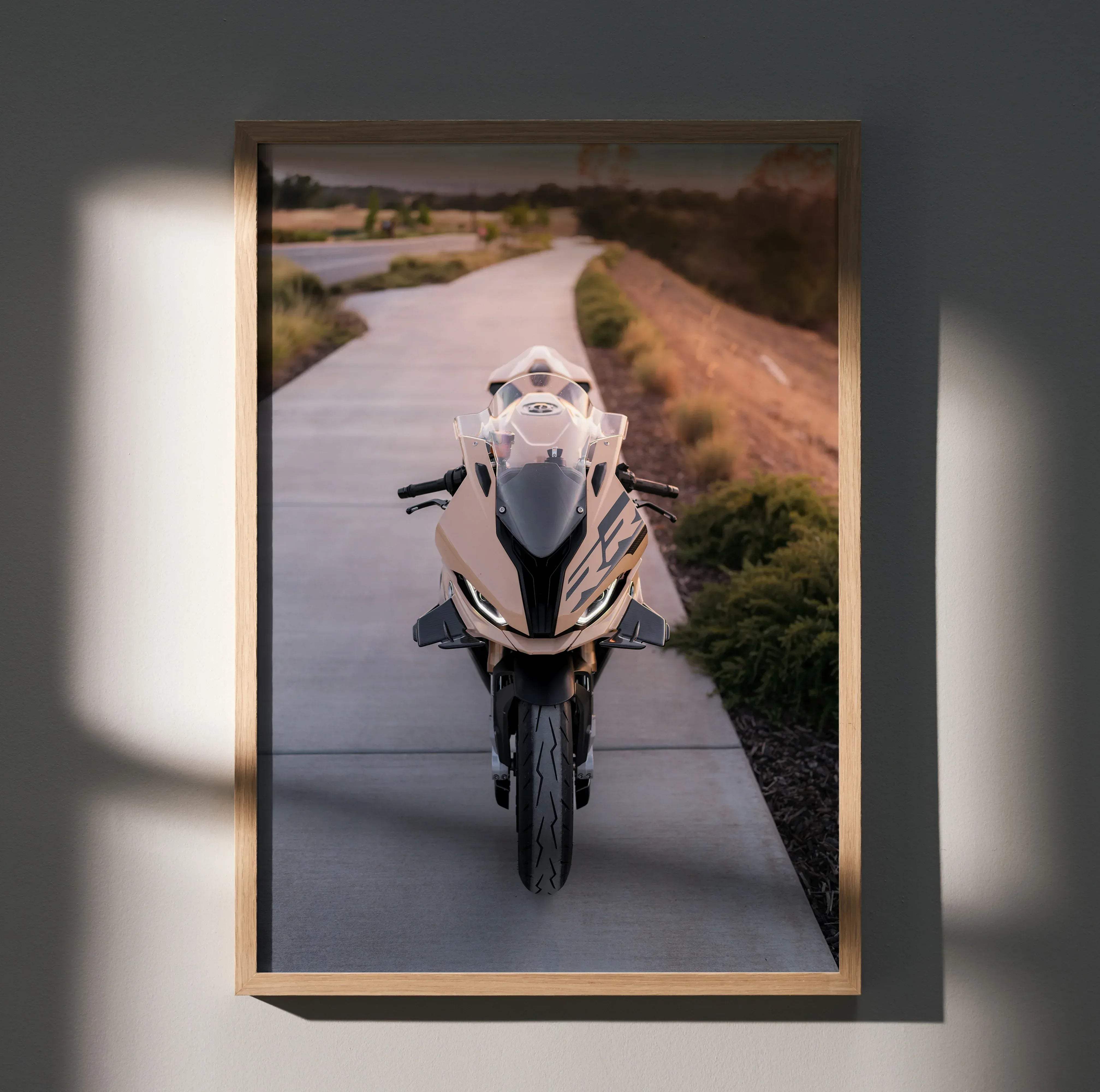 A framed BMW inspired S1000RR high resolution poster featuring a beige and black sport motorcycle on a paved road