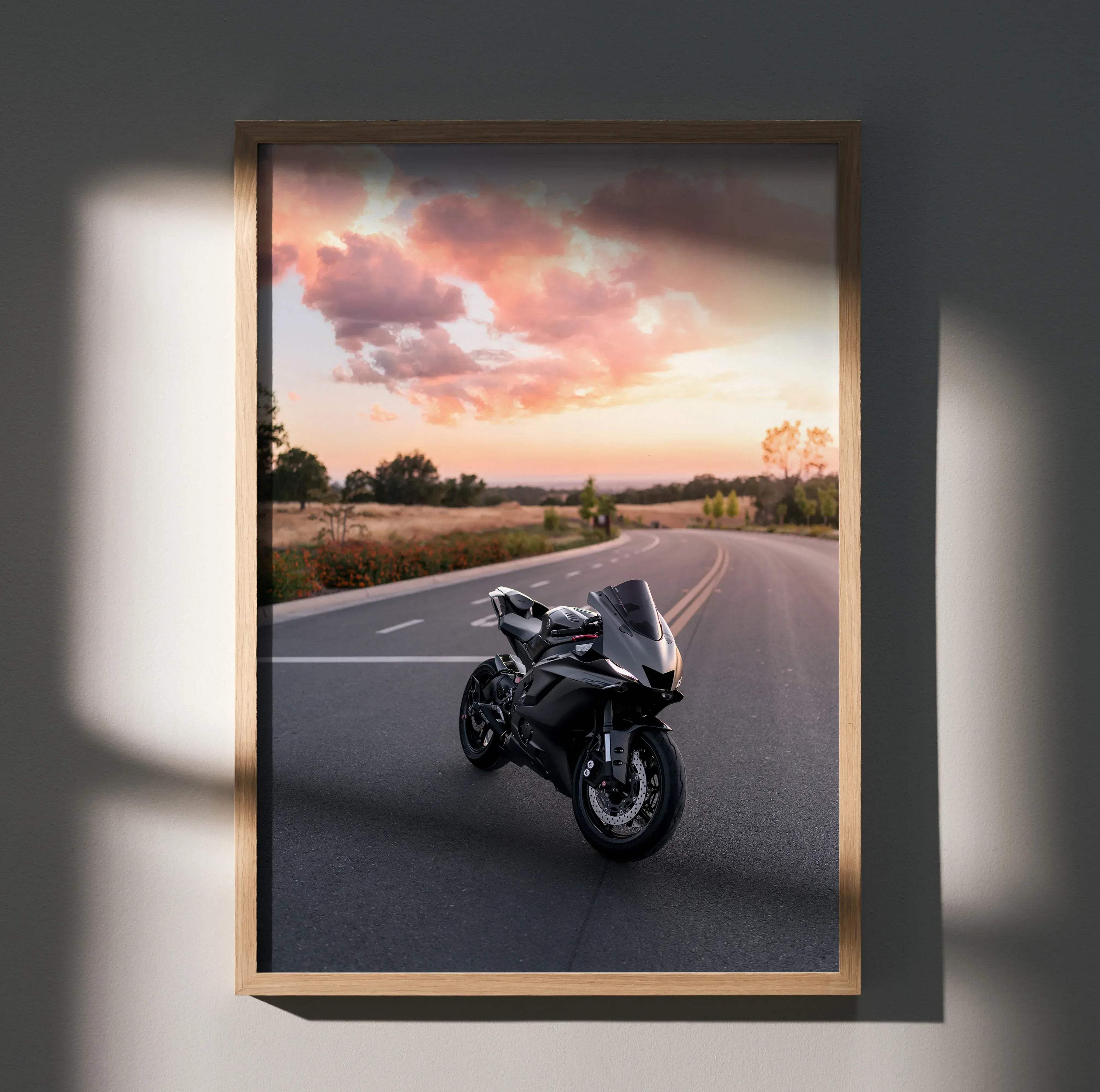 Framed Yamaha R6 motorcycle poster featuring a black sport bike with sleek aerodynamic design and glossy finish at sunset