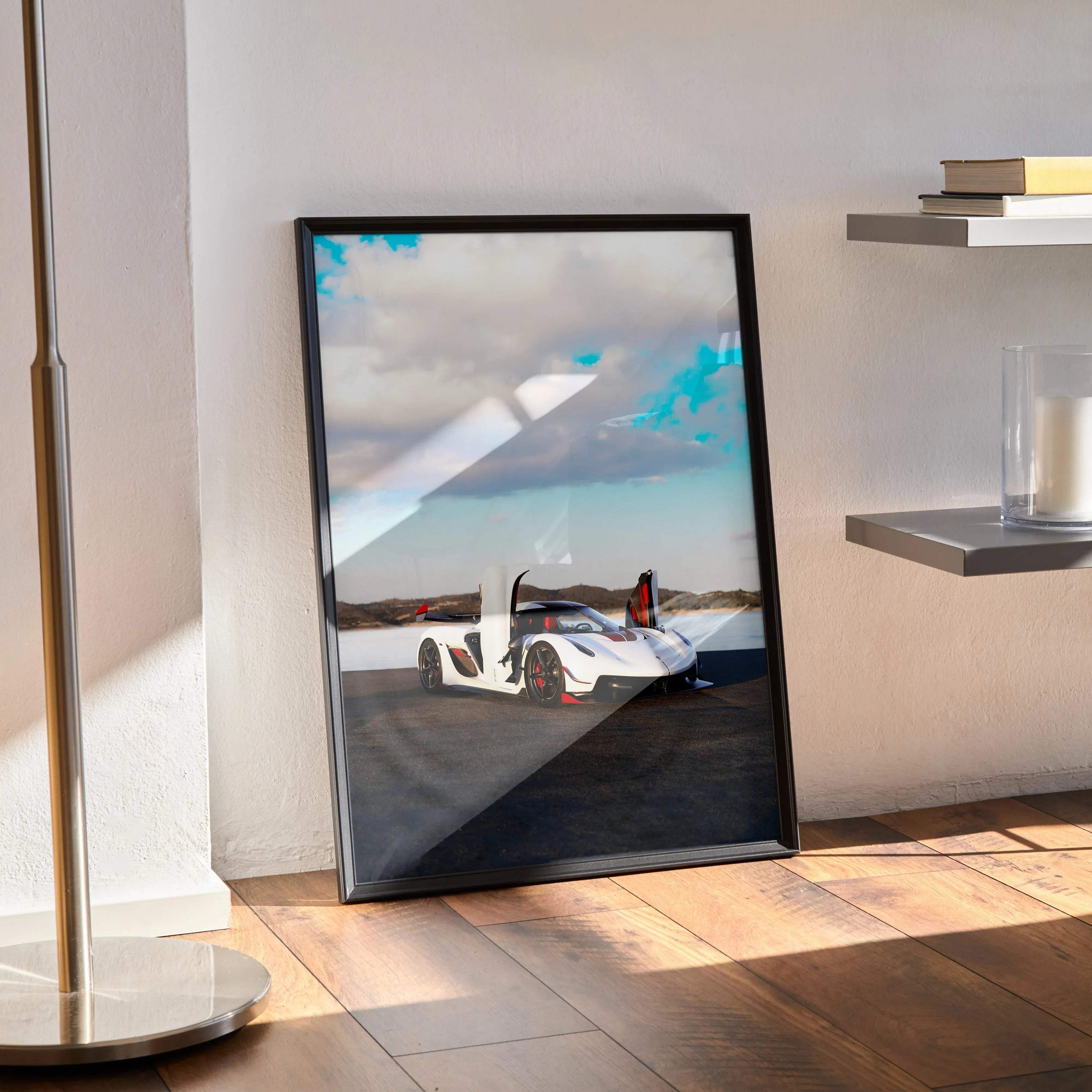 Black-framed poster of white koenigsegg jesko hypercar with red accents and open doors against cloudy sky