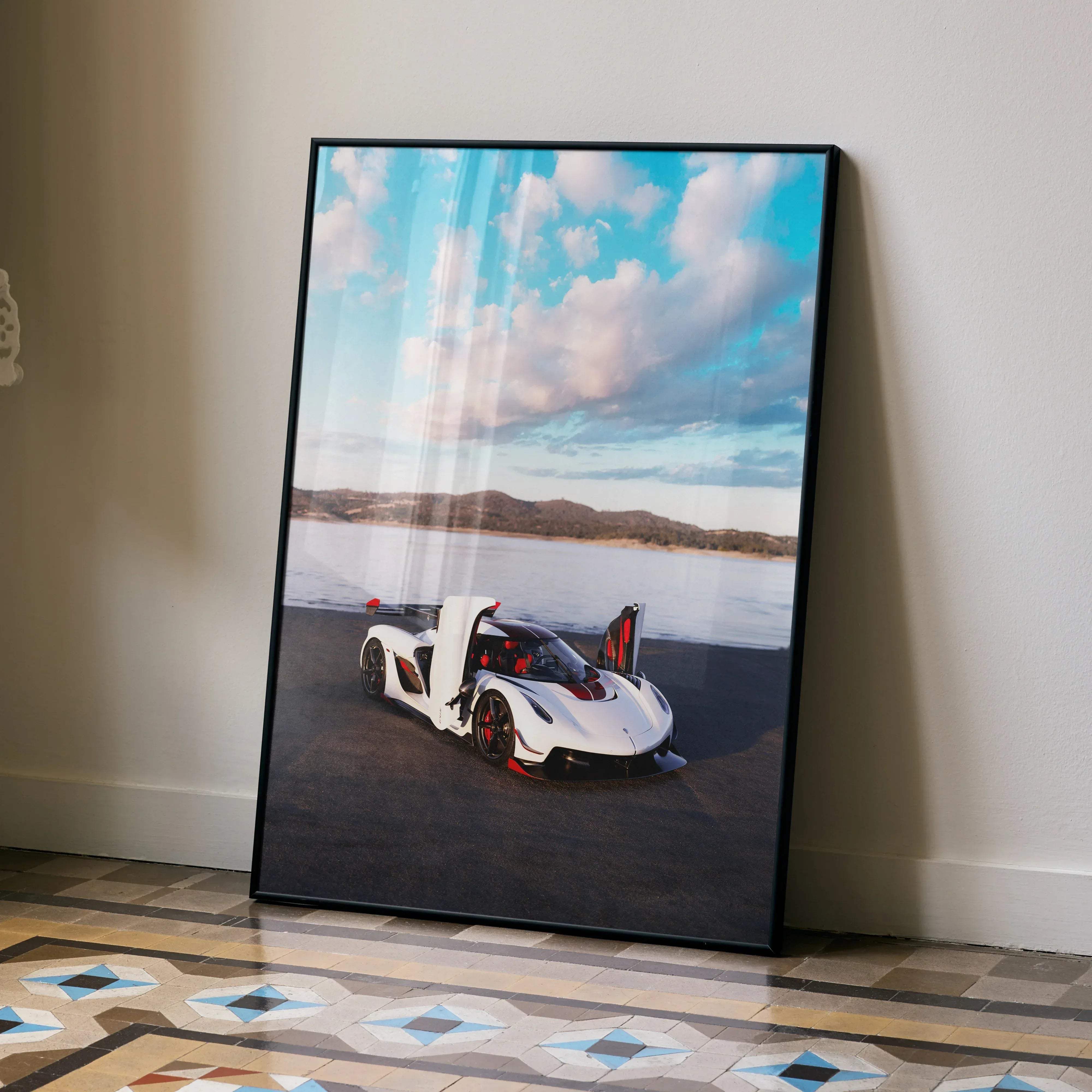 Black-framed koenigsegg jesko poster featuring a white and red hypercar with open doors against blue sky and clouds