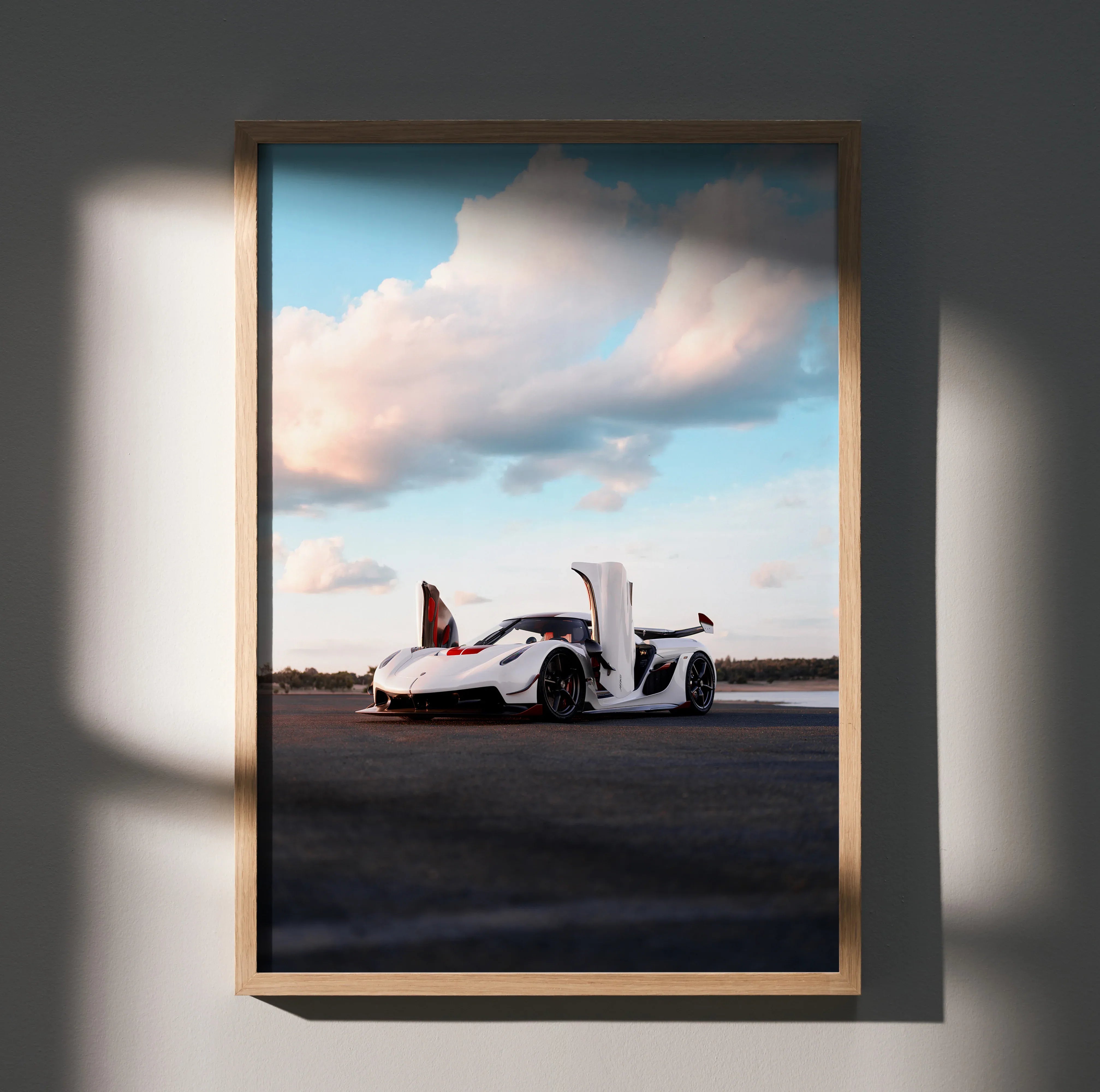 Koenigsegg Jesko sports car with open doors under blue sky poster wall art in wooden frame.