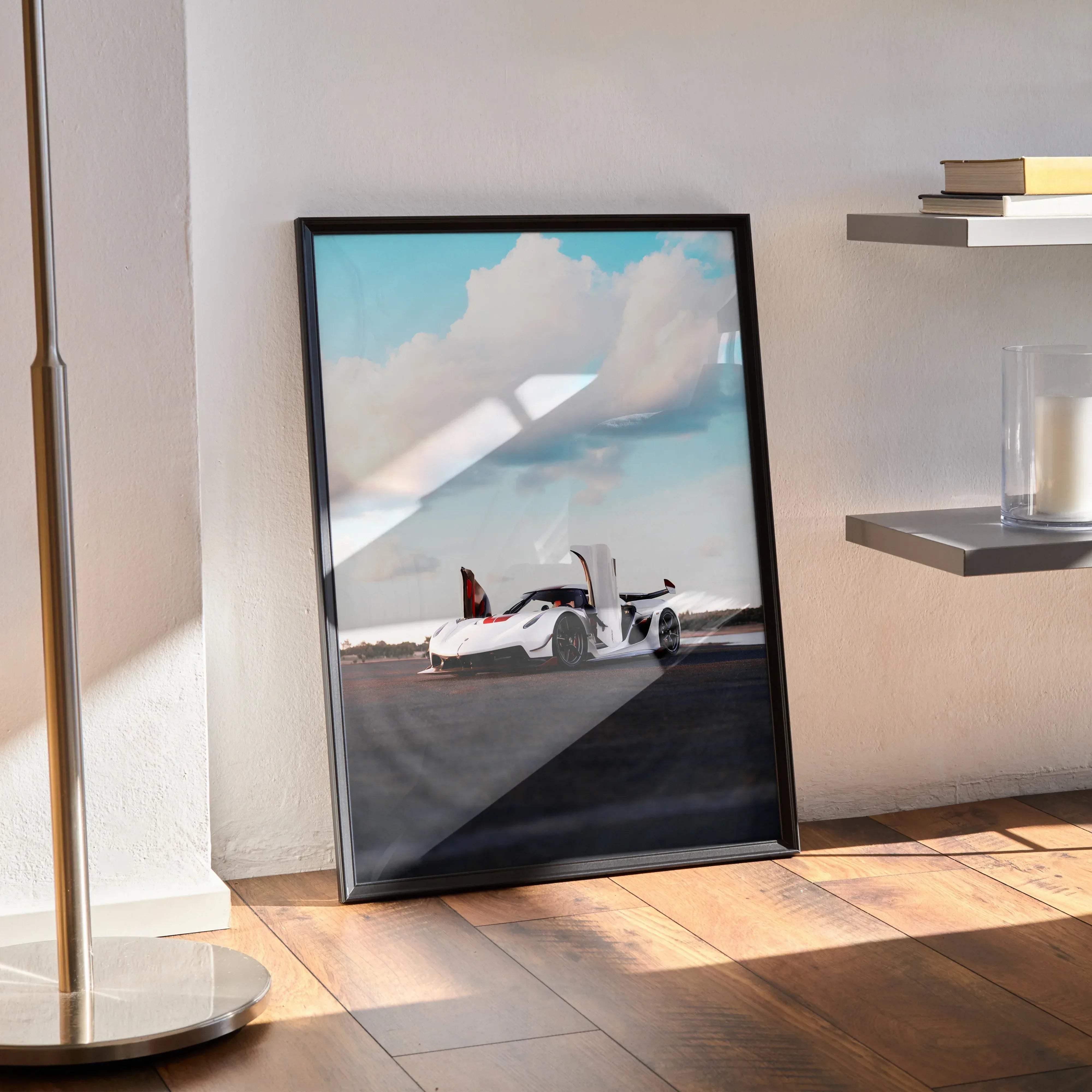 Black-framed koenigsegg jesko car poster featuring a white sports car with red accents under a cloudy sky