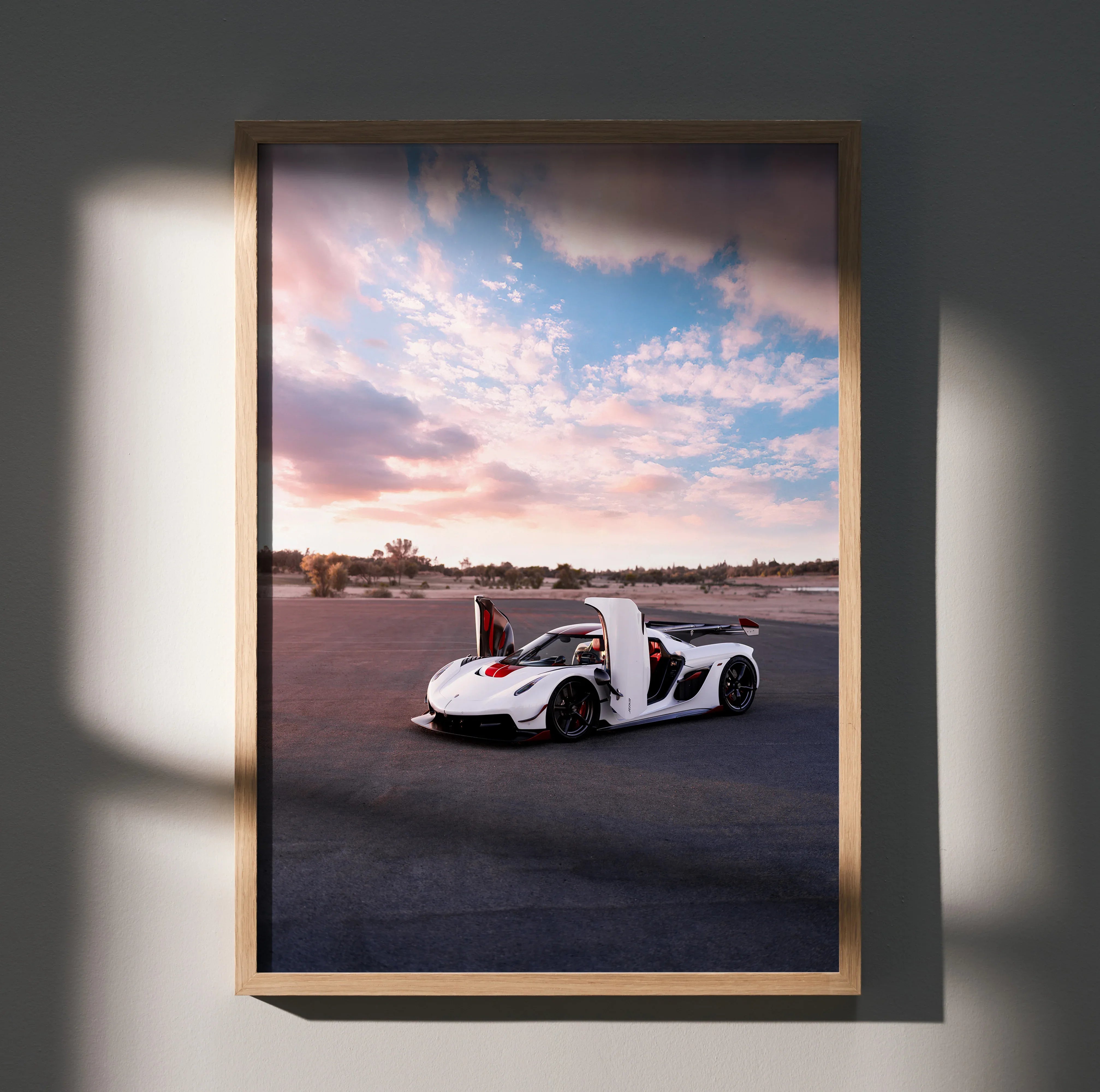 Koenigsegg Jesko car poster with white sports car under a colorful sunset sky, wall art.