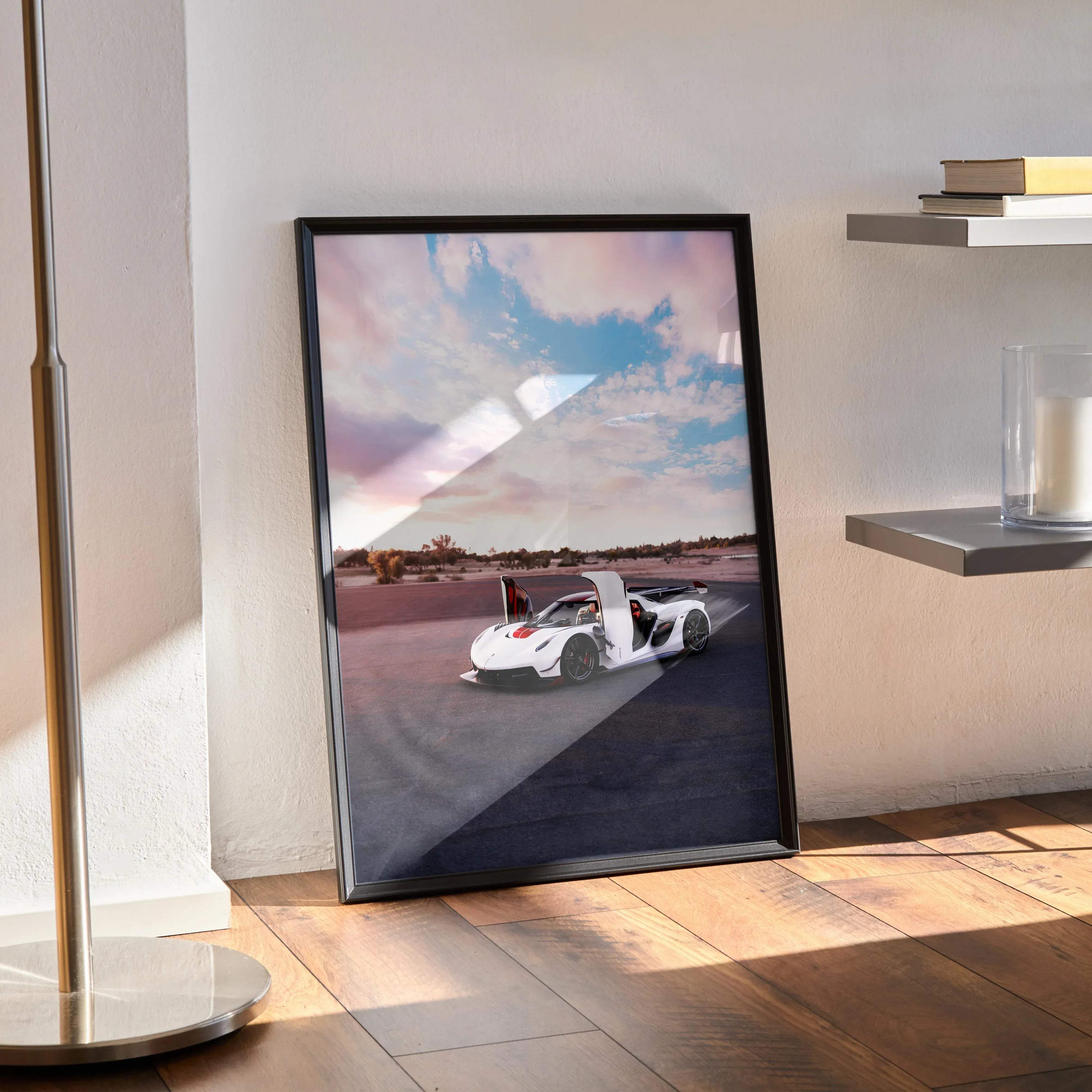 Black-framed poster of a white koenigsegg jesko hypercar with open doors against pink and blue sky clouds