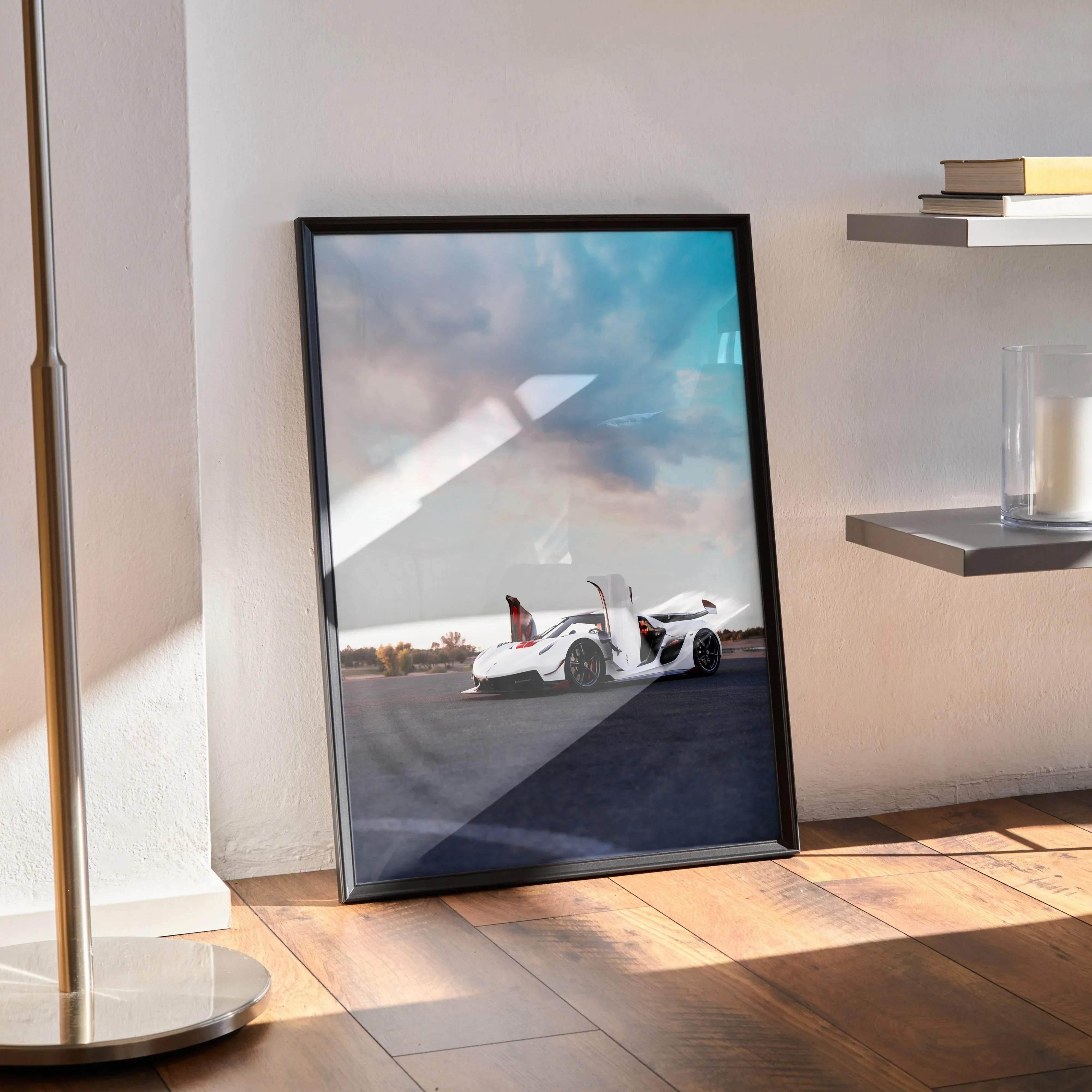 Black-framed poster featuring a white koenigsegg jesko sports car with open doors under a dramatic sky