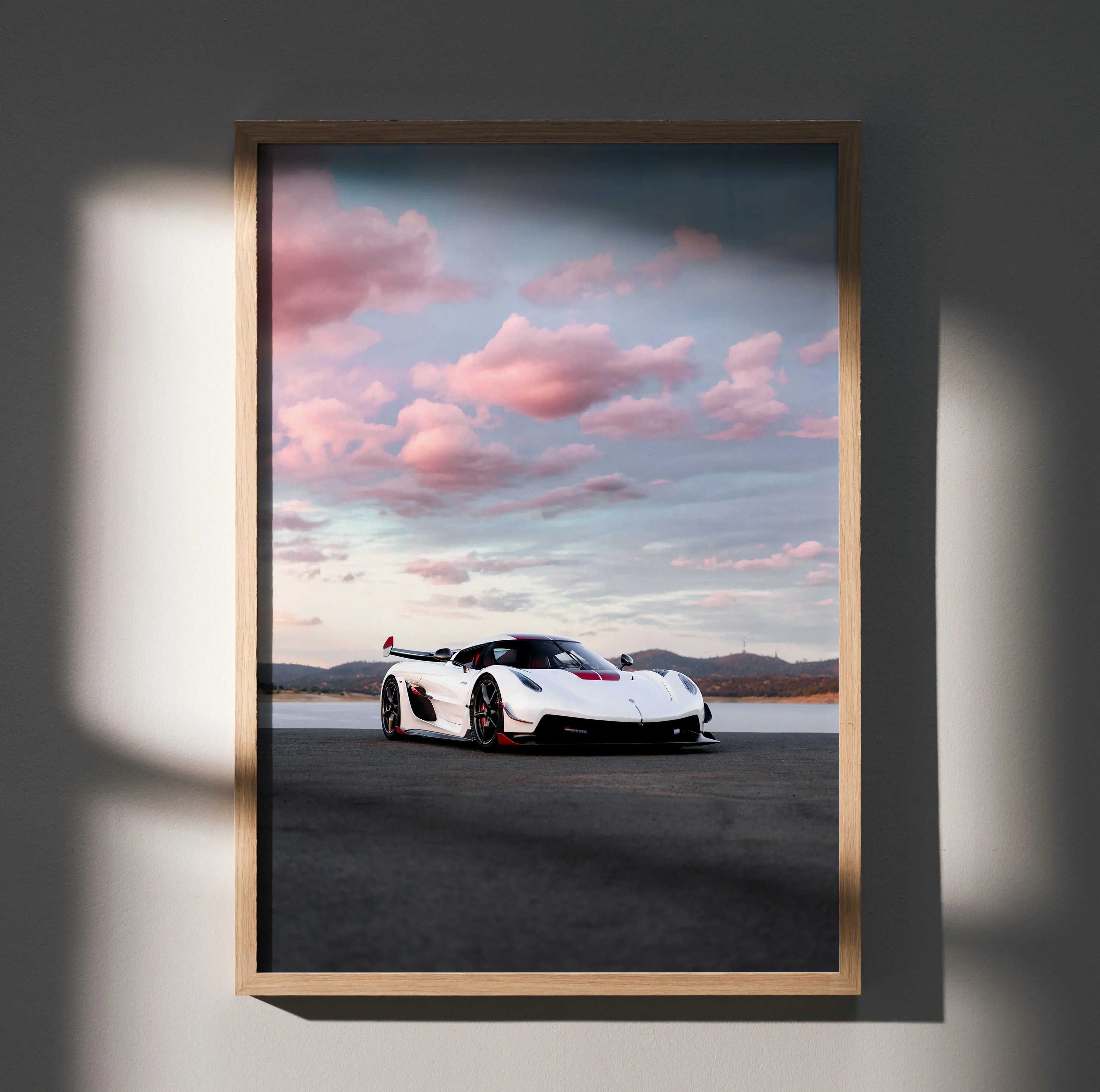 Koenigsegg Jesko poster with white sports car under a pink and blue sky, wall art in wooden frame.