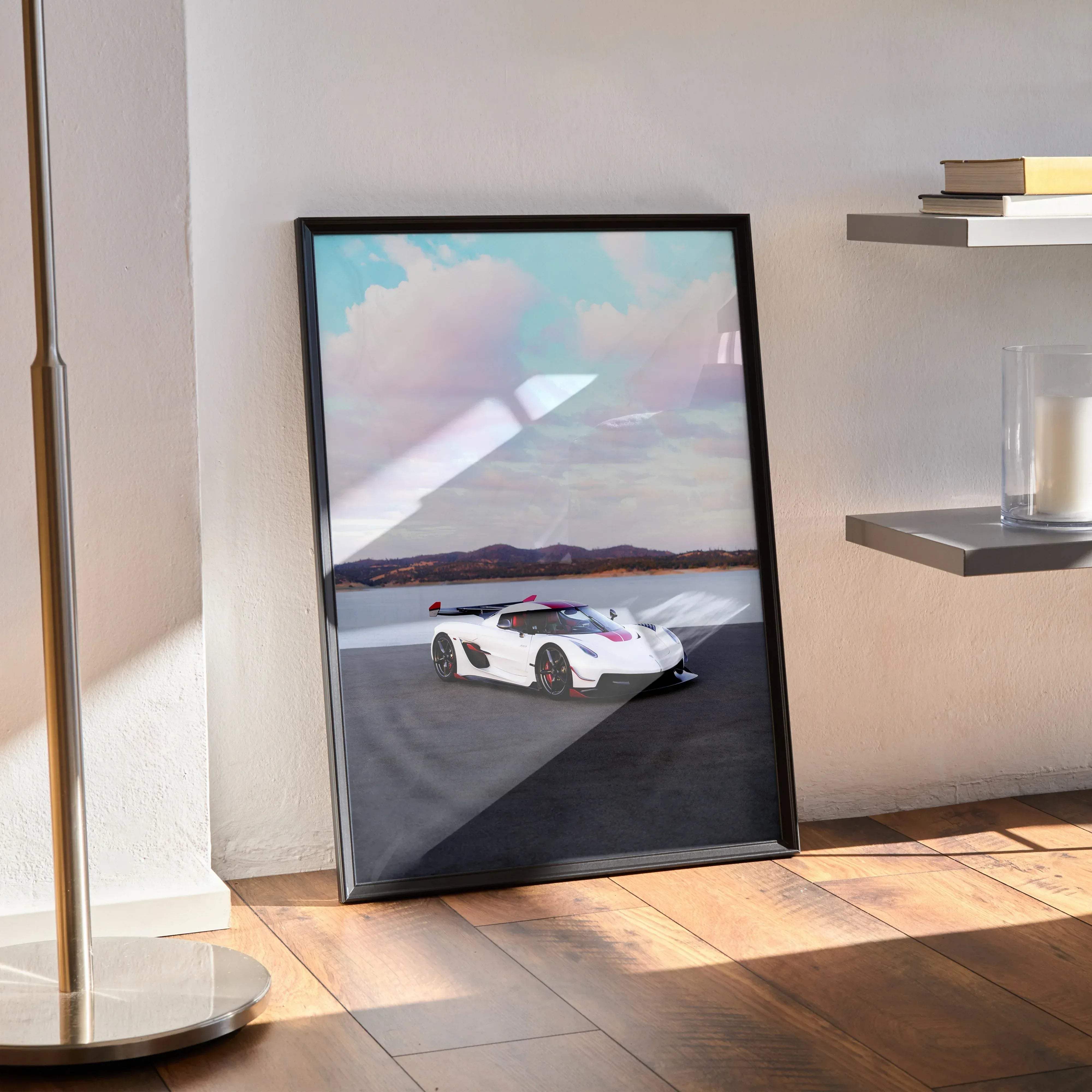 Black-framed koenigsegg jesko car poster featuring a white and red hypercar speeding on track under pastel sky