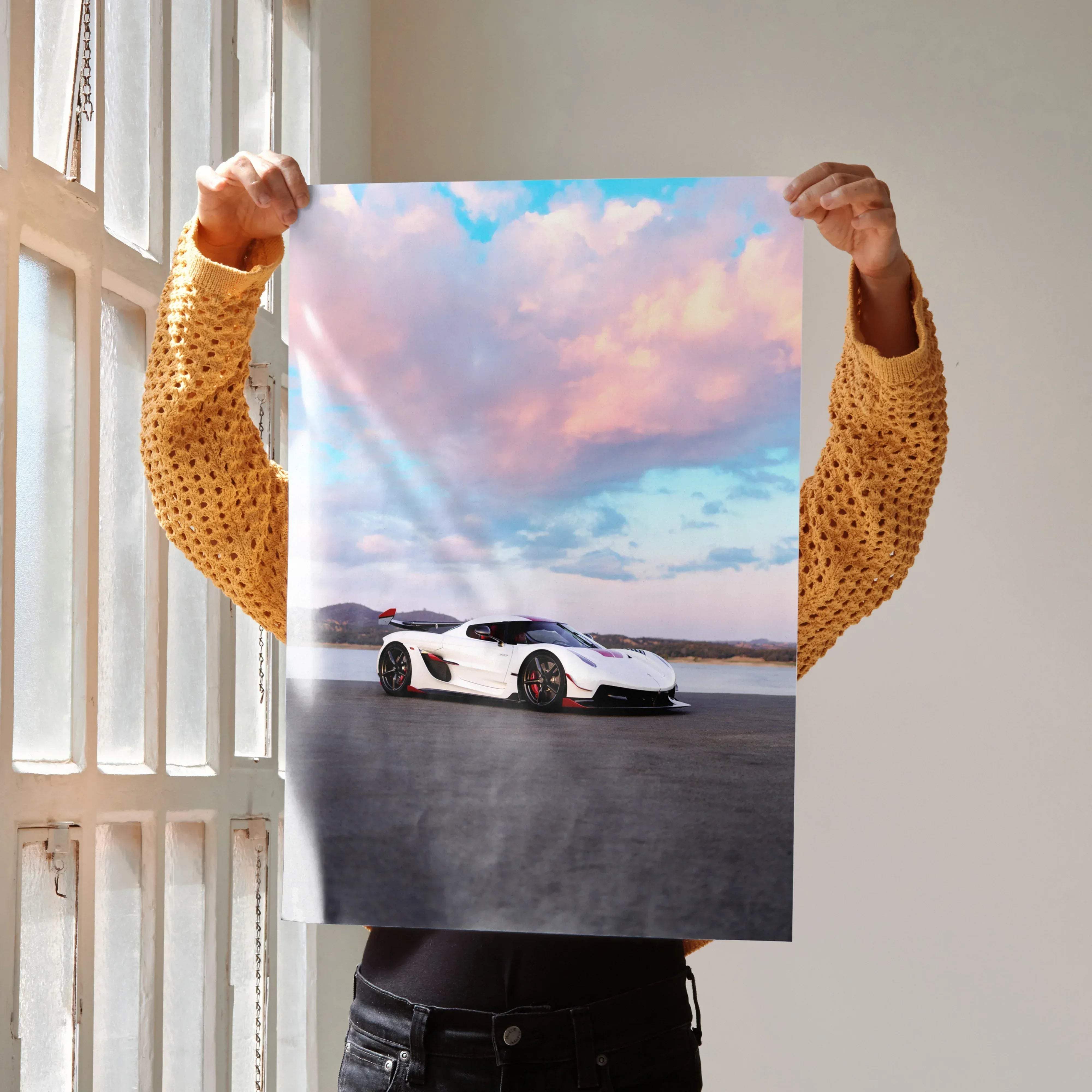 Koenigsegg Jesko high resolution car poster featuring a white sports car with red accents under a pink and blue sky