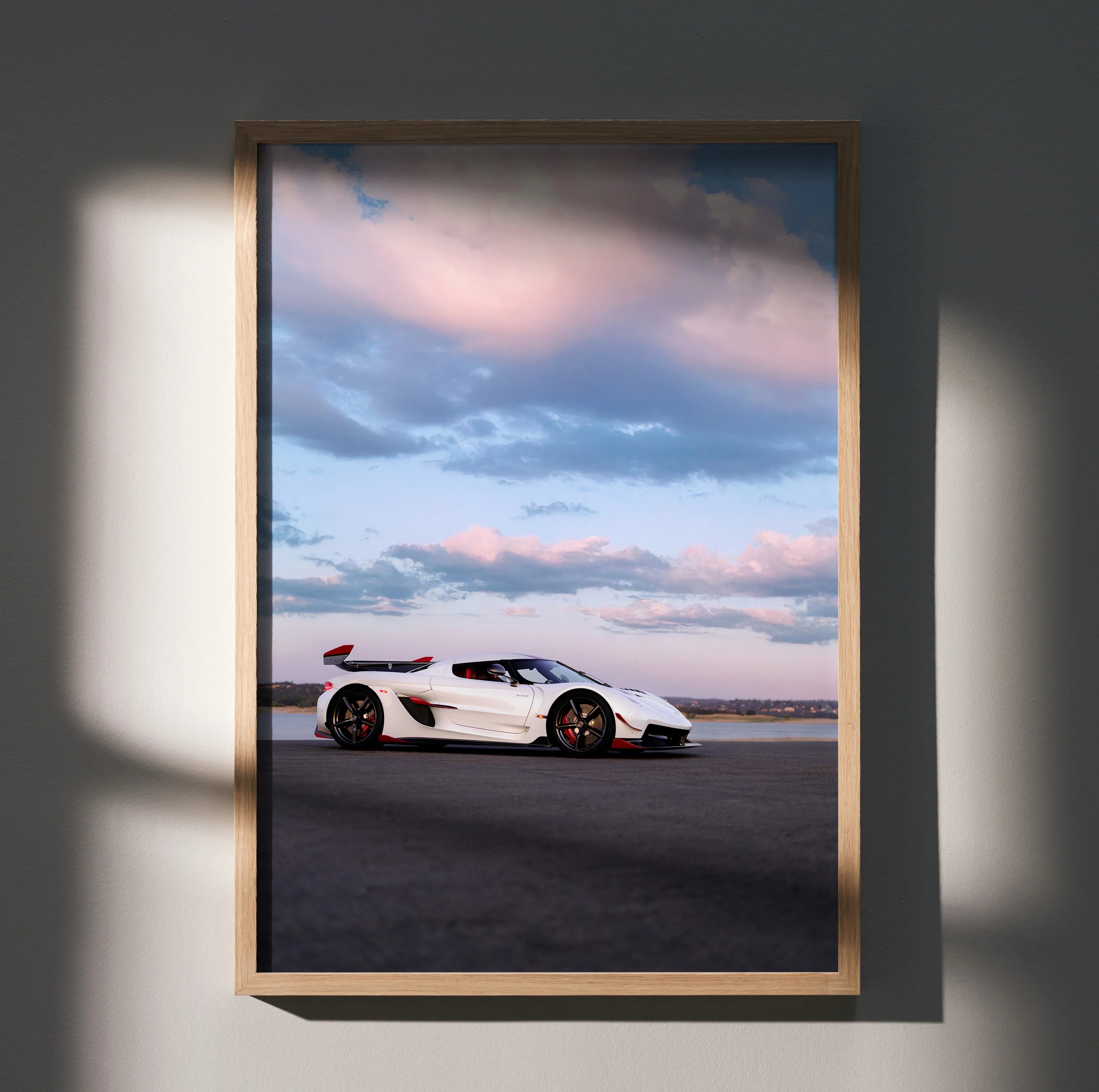 Koenigsegg Jesko white sports car poster with dramatic sky, sleek design, wall art in wooden frame.