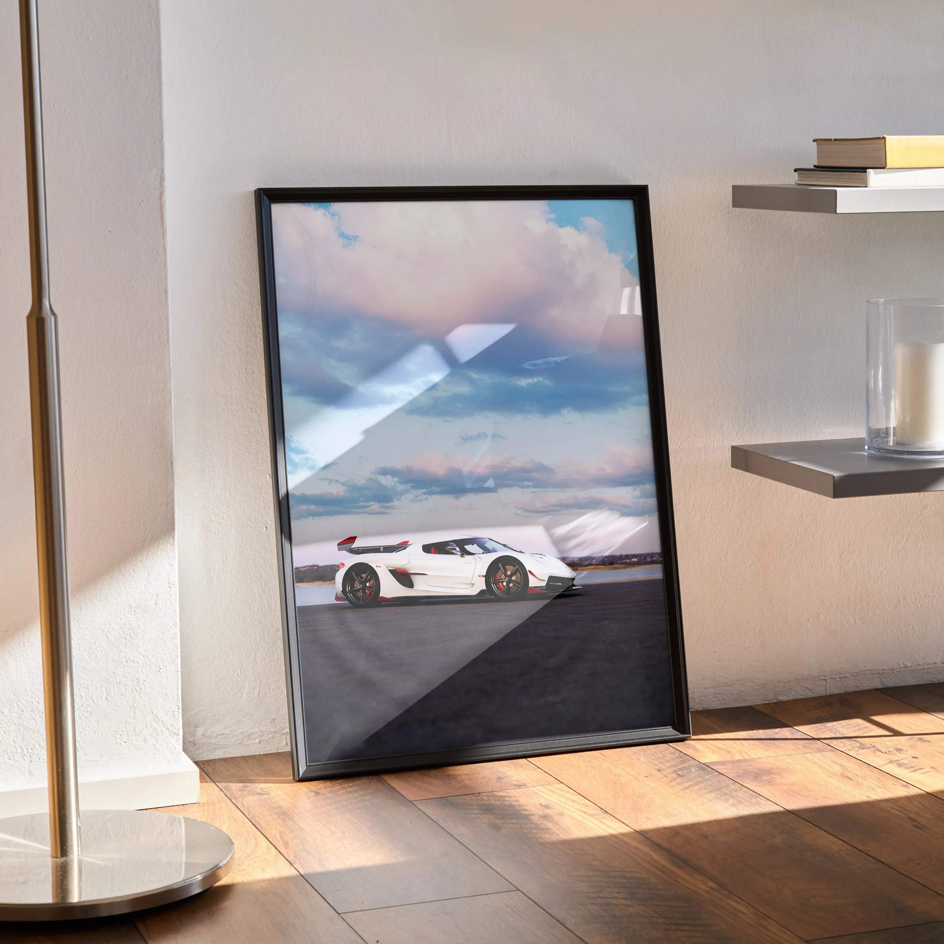 Black-framed poster of a white koenigsegg jesko sports car with red accents under a cloudy sky high resolution print