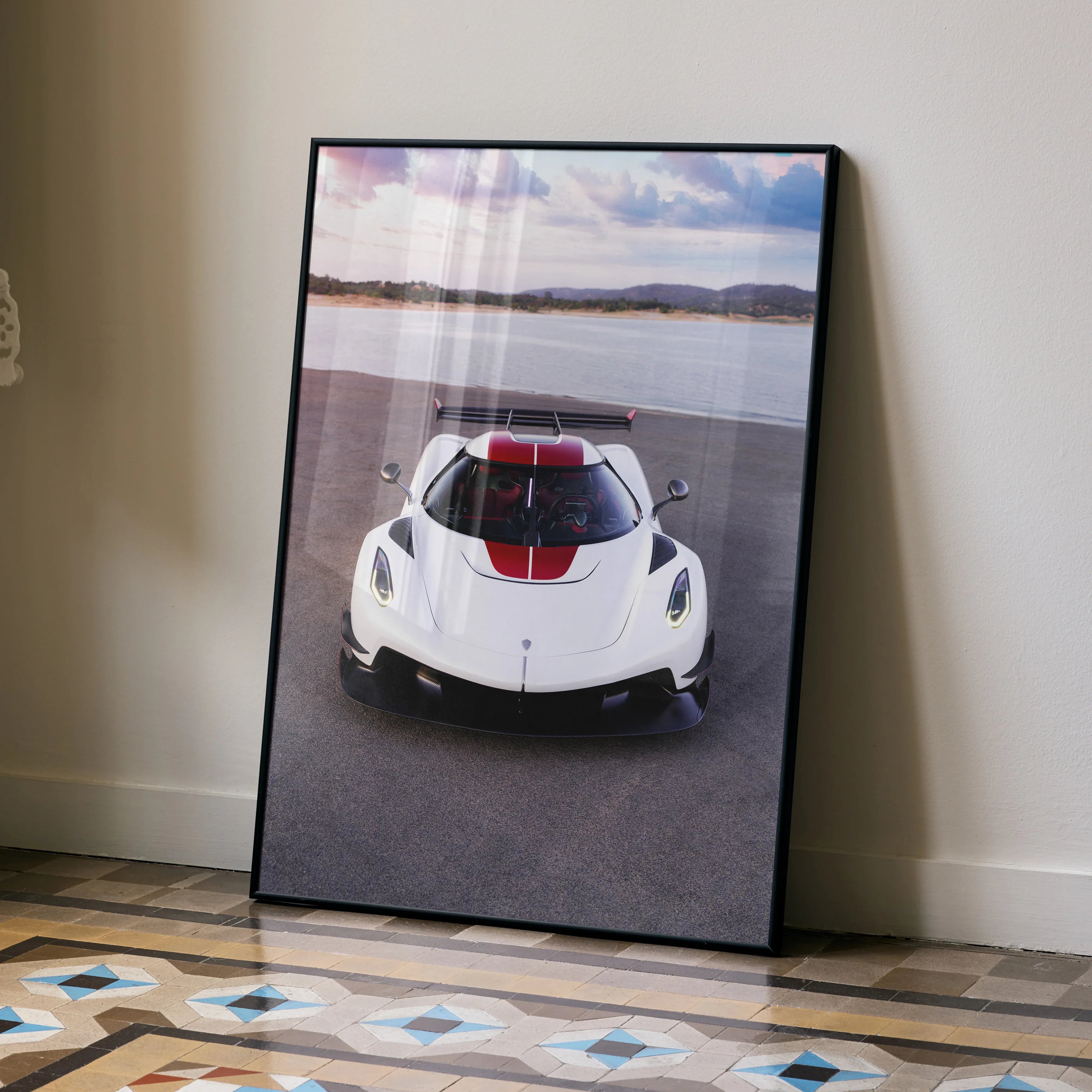 Koenigsegg Jesko white sports car poster leaning against wall with scenic background wall art.