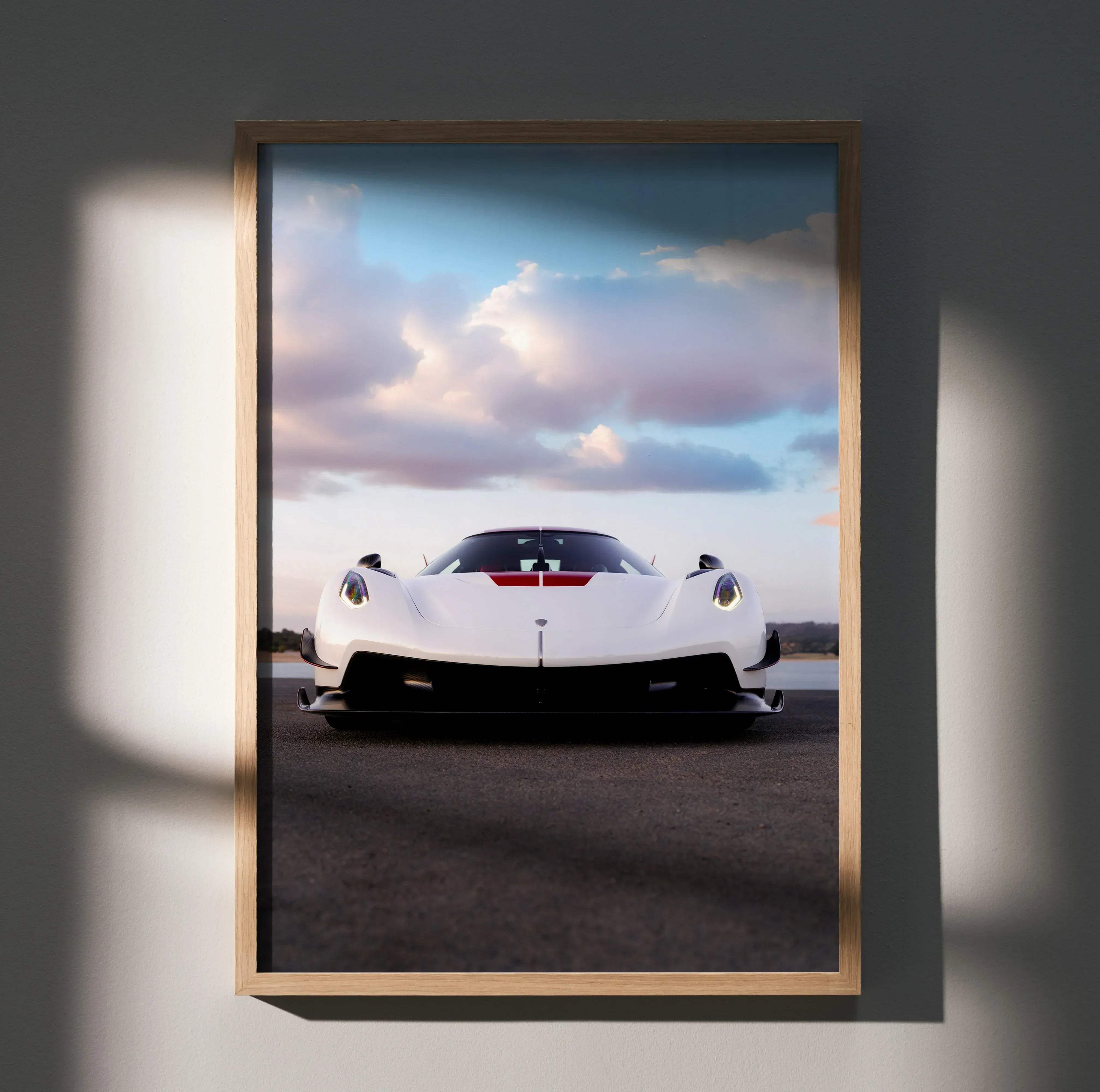 A framed light wood photo poster of a white Koenigsegg Jesko sports car with red accents high resolution print