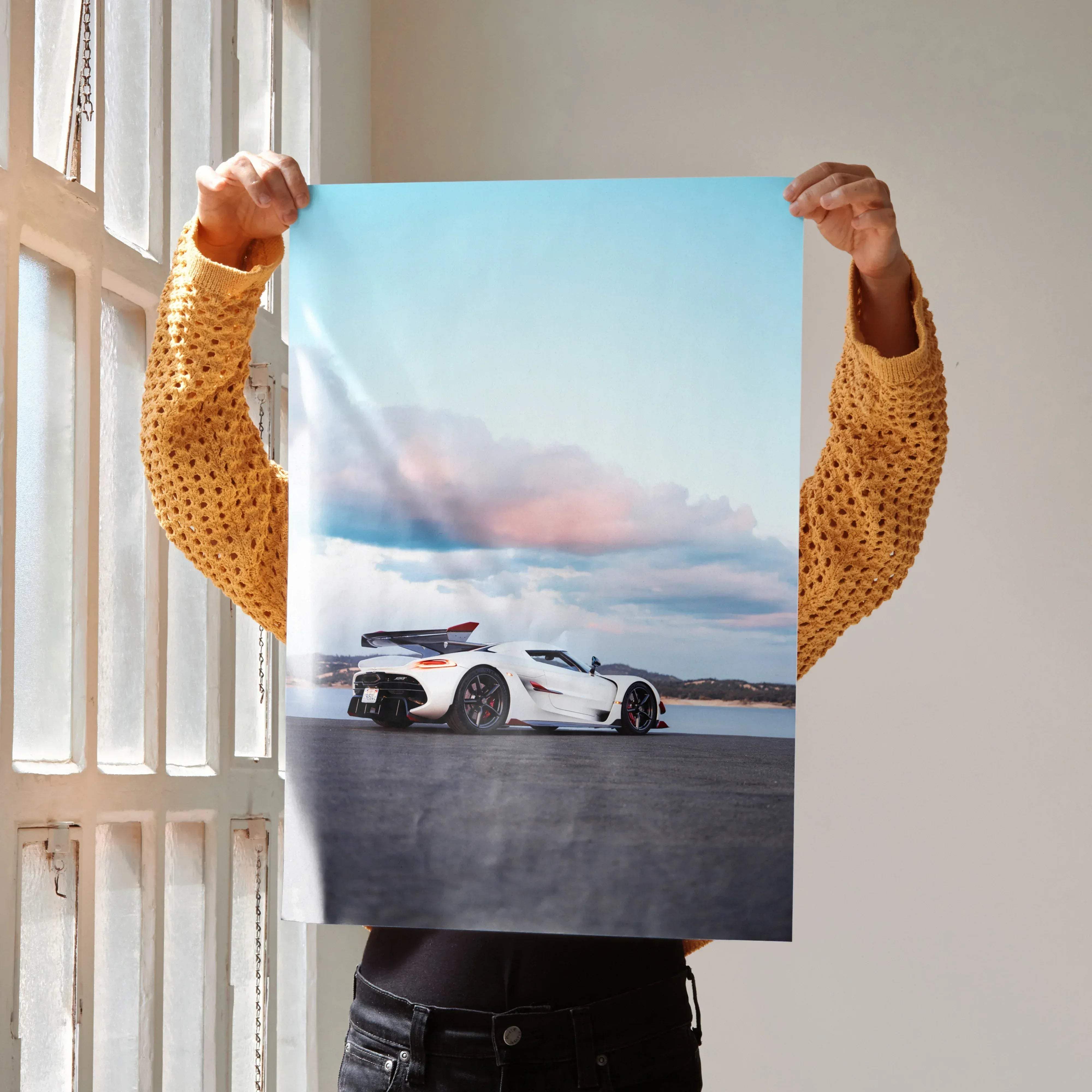 White Koenigsegg Jesko hypercar poster showing a dynamic drift under soft blue sky with pink clouds high resolution