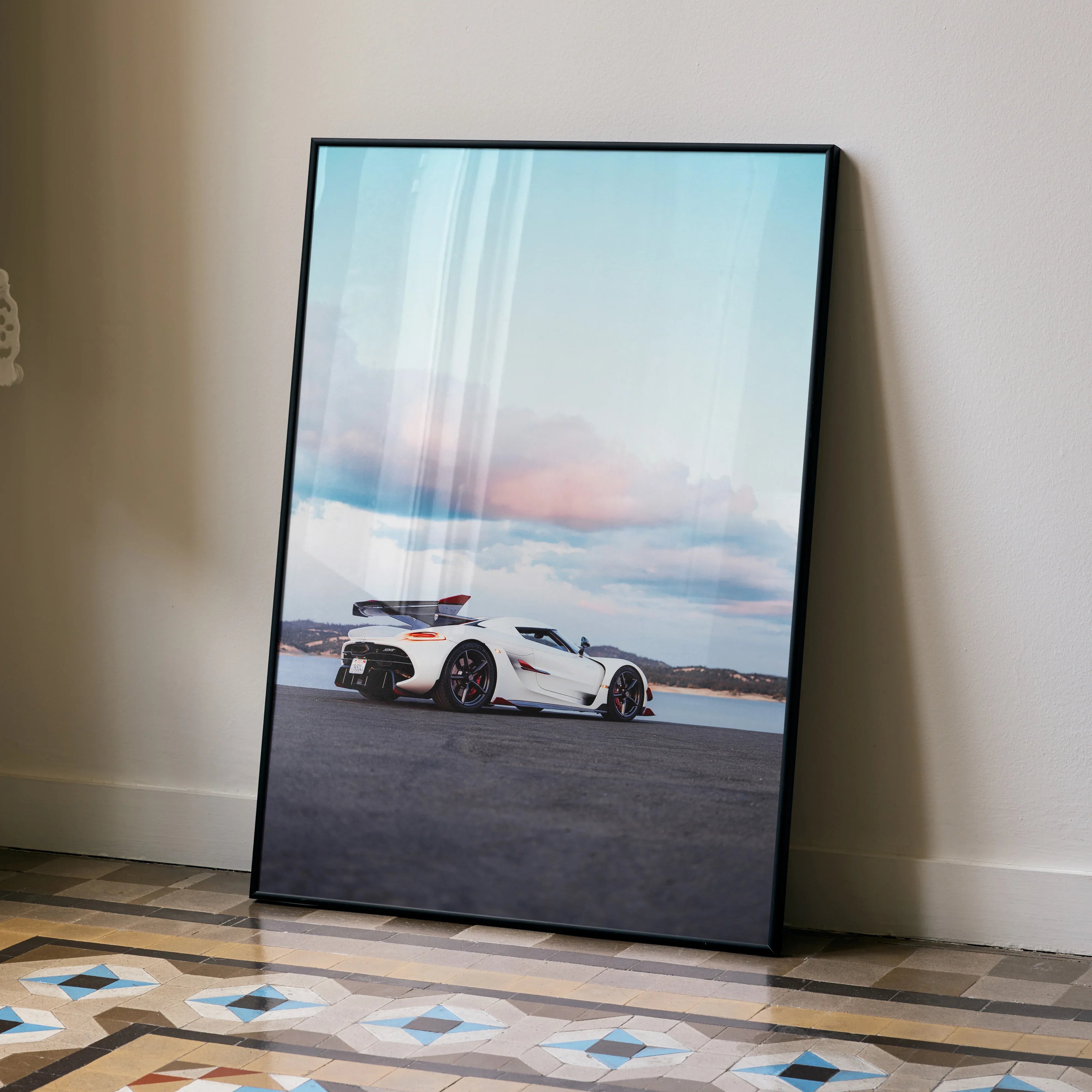 Koenigsegg Jesko poster featuring white sports car on open road under pastel sky wall art.