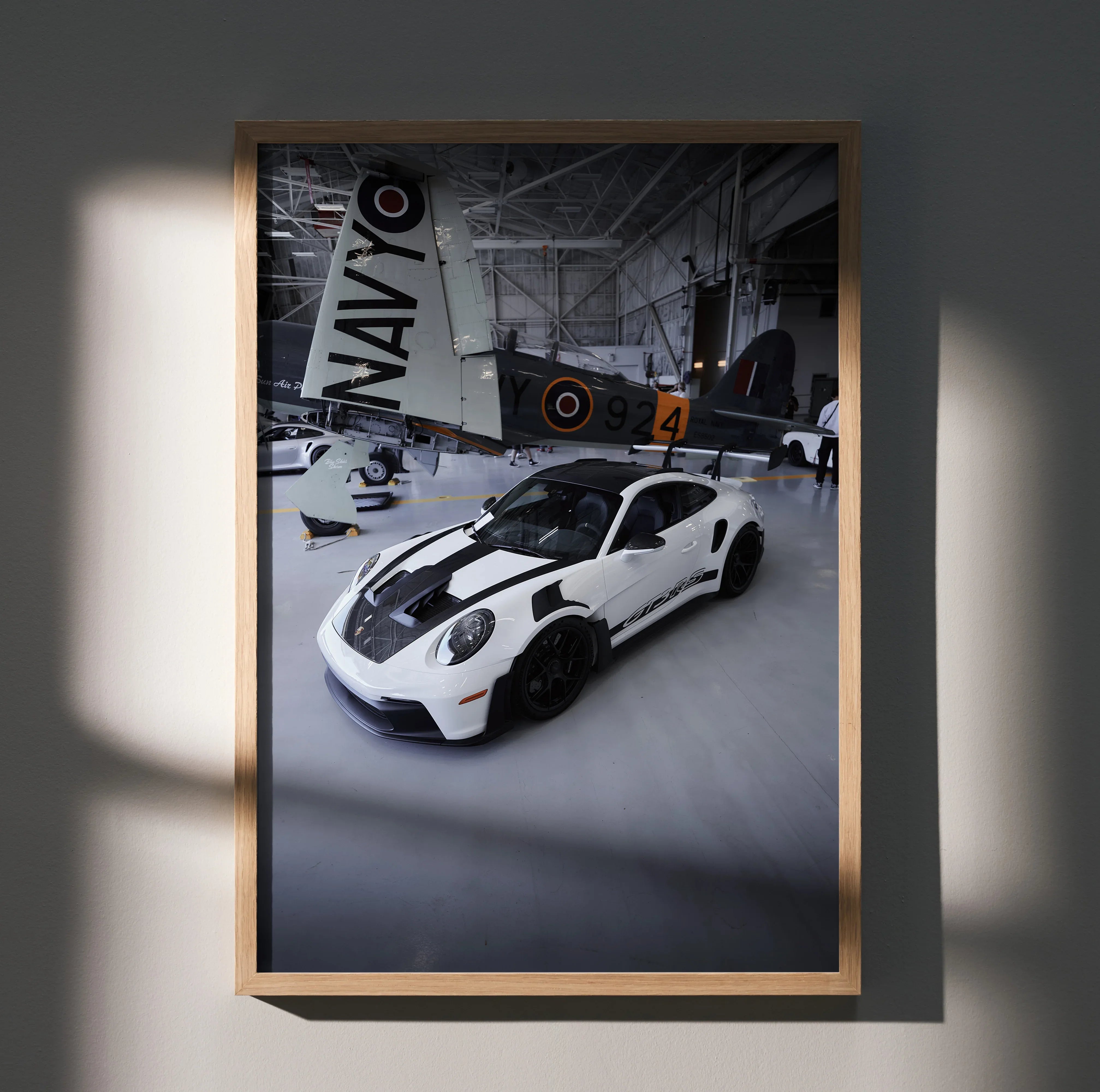 Porsche 911 GT3 RS poster with white sports car and vintage airplane background wall art.