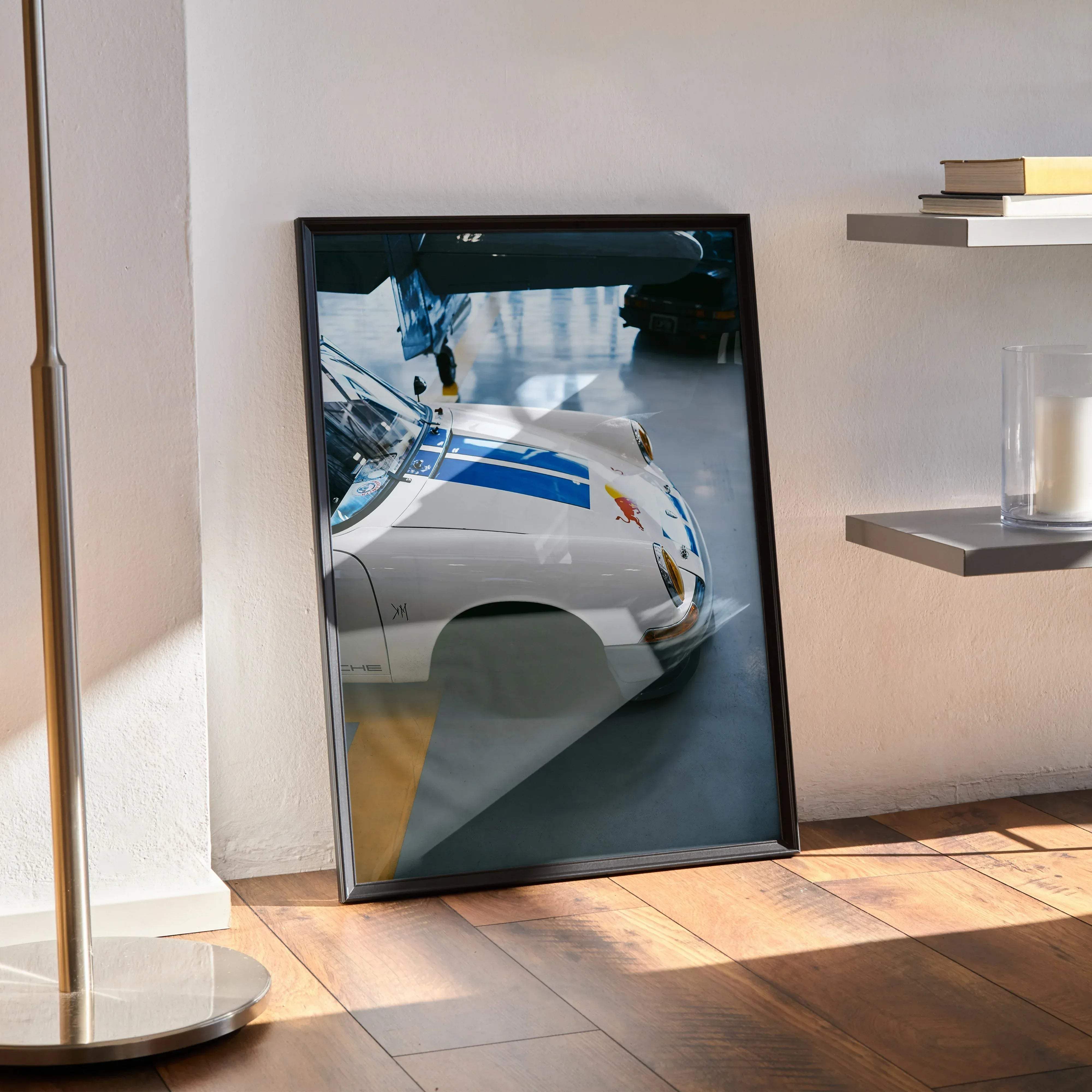 Framed poster of a white Porsche 911 with blue racing stripes and Red Bull sponsorship decals in high resolution