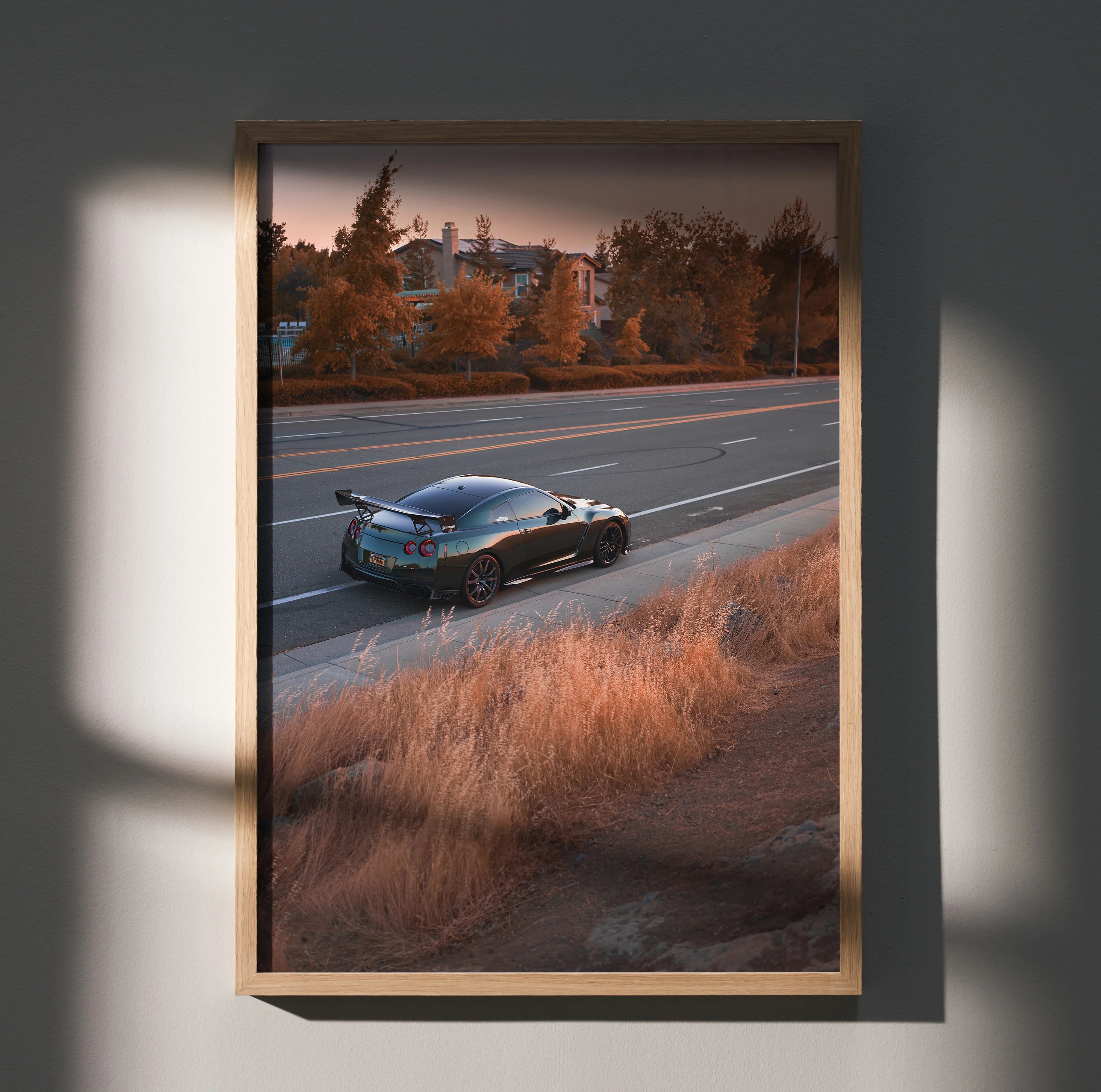 Nissan R35 GTR driving on highway at sunset high-resolution poster wall art in wooden frame.