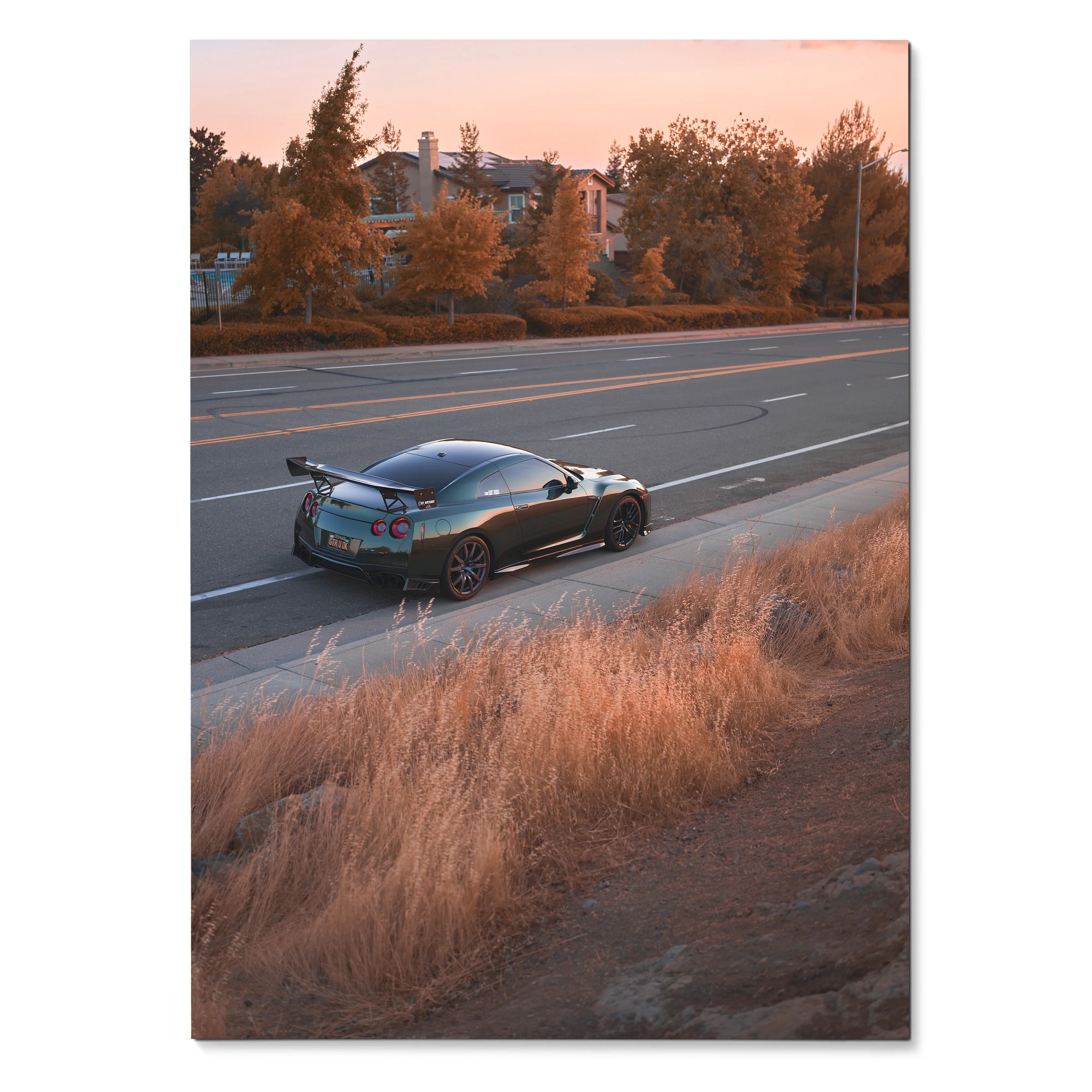 Nissan GTR R35 parked by roadside at sunset with warm light poster wall art.