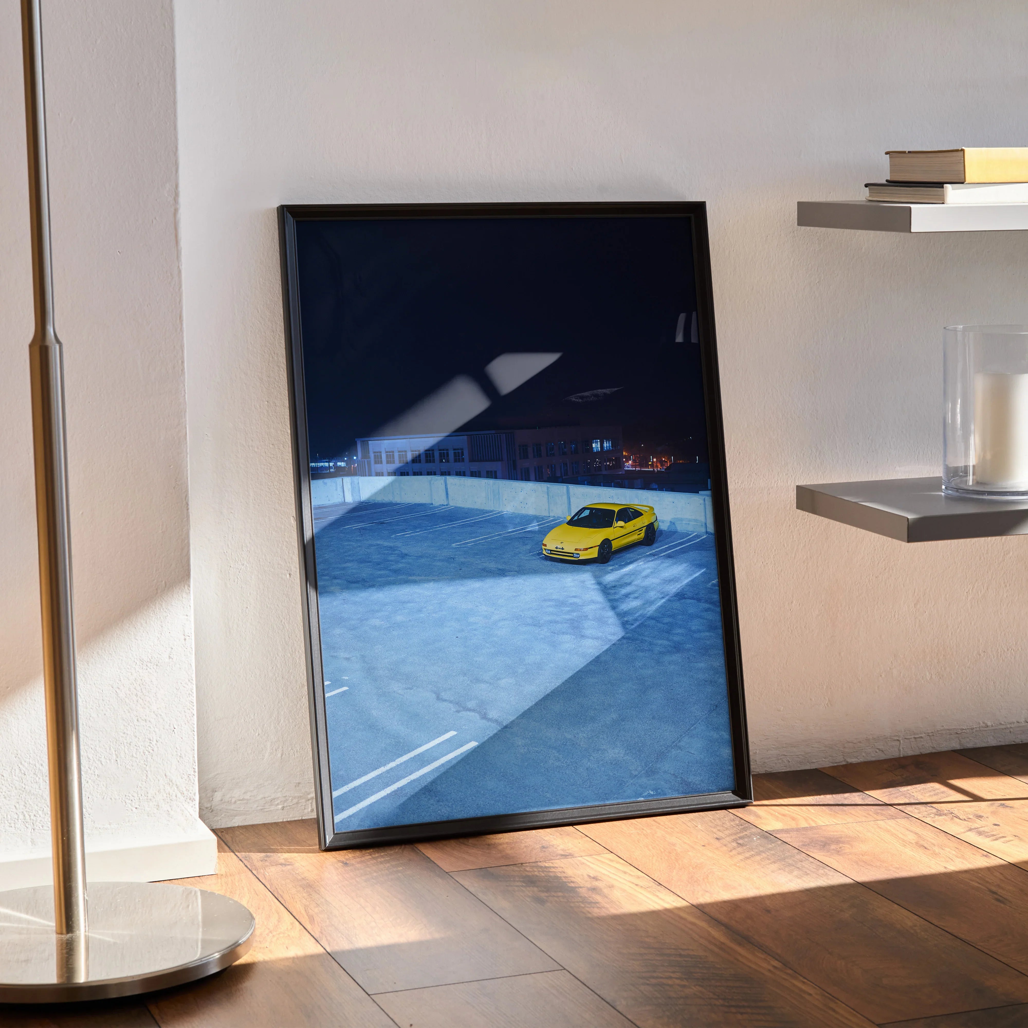 Toyota MR2 poster wall art featuring a yellow sports car on a blue racetrack backdrop.