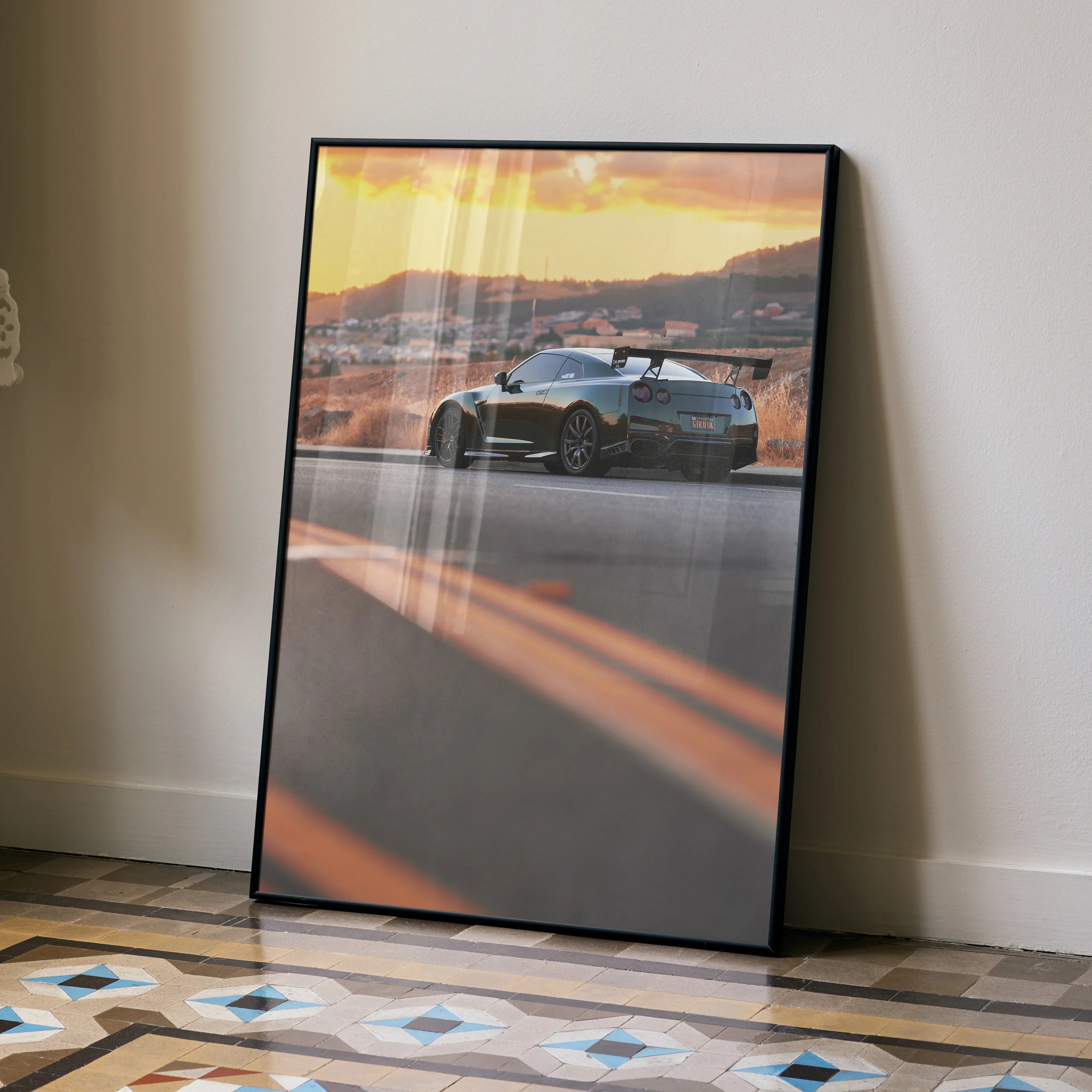 Nissan GTR R35 poster with sunset backdrop, sleek car silhouette, framed wall art.