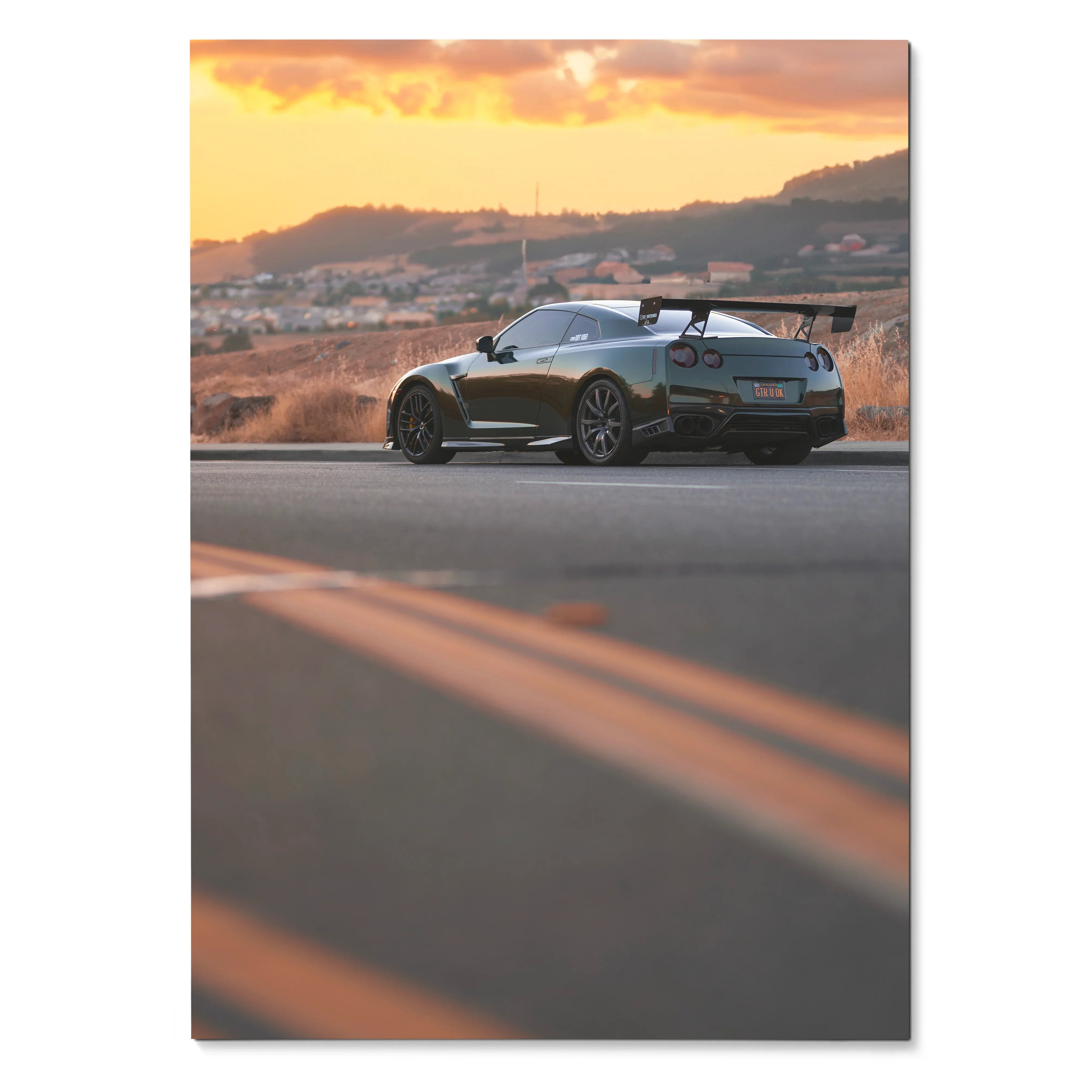 Nissan R35 GTR parked on road at sunset with hills in background poster wall art.