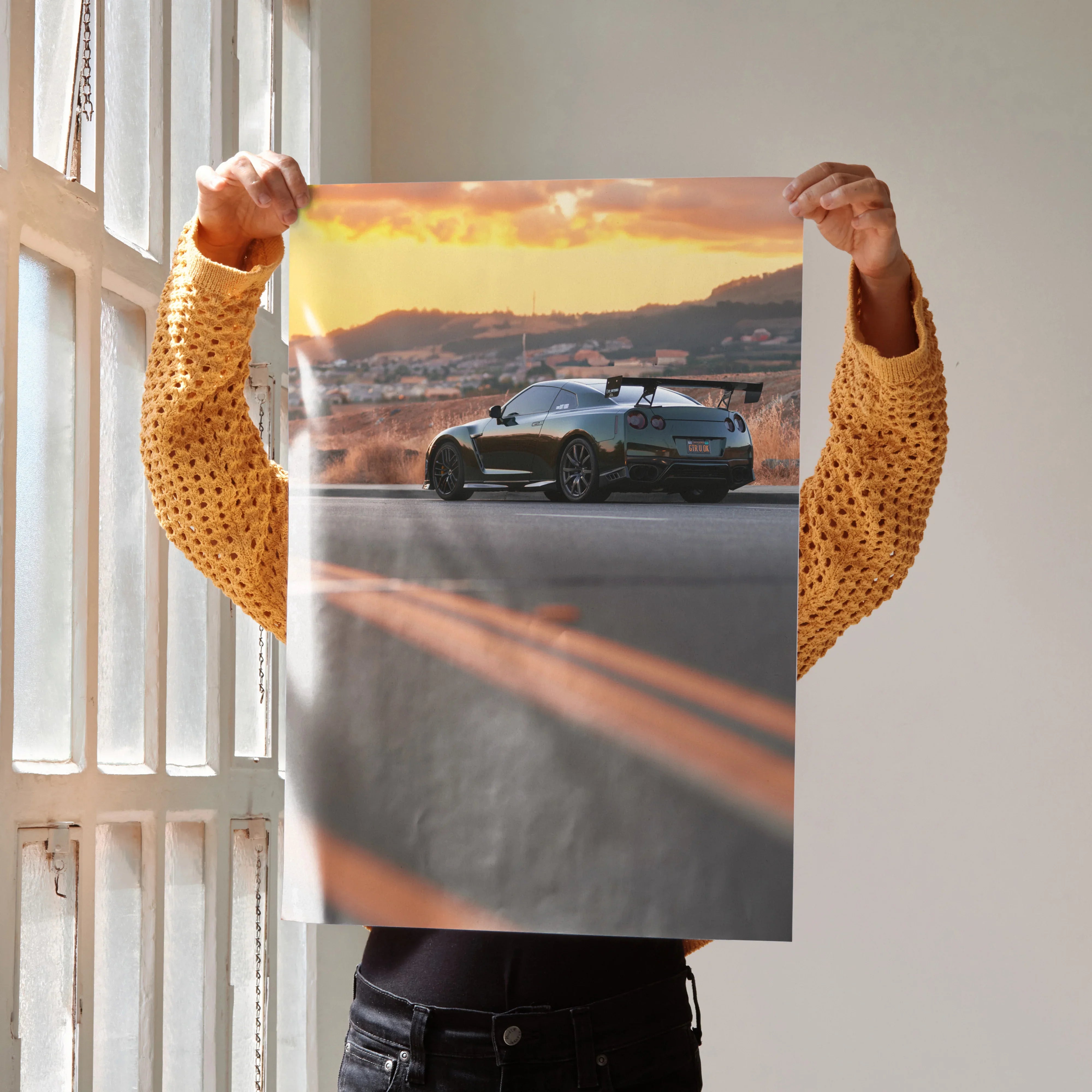 Nissan GTR R35 parked on road at sunset poster wall art with vibrant sky colors.
