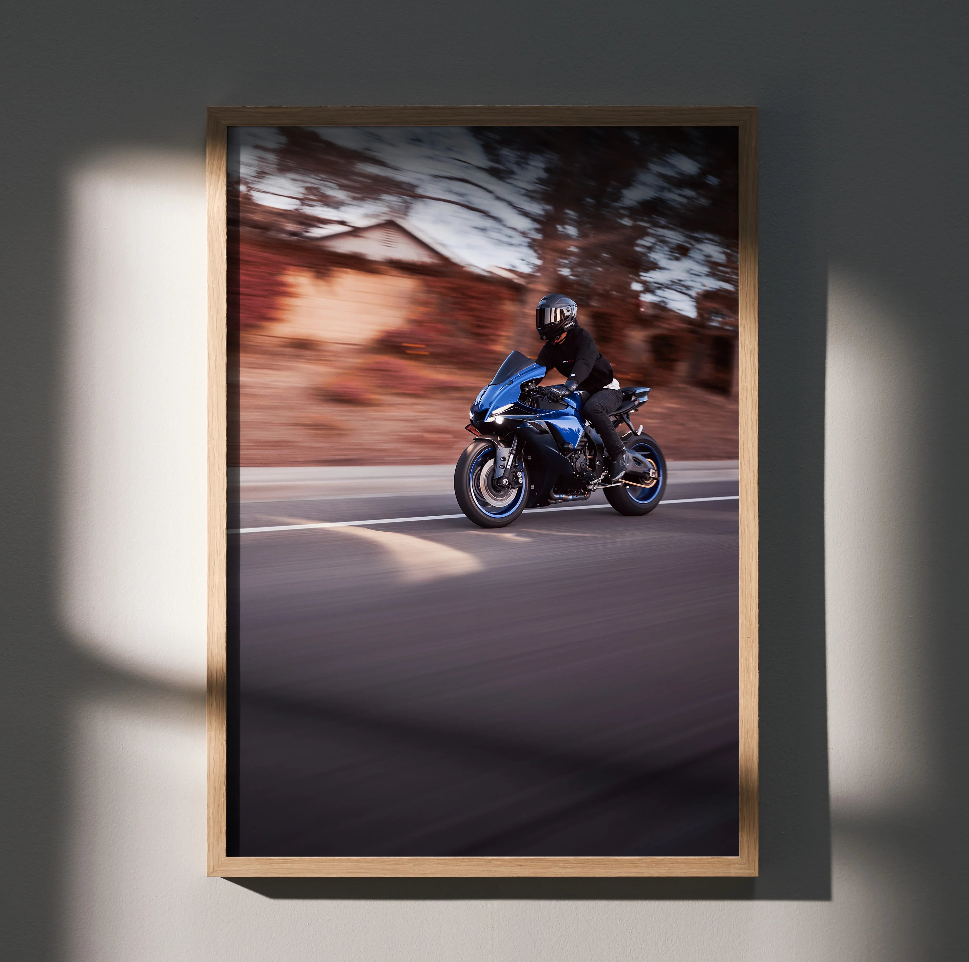 Yamaha R1 motorcycle riding at speed poster wall art in wooden frame with blurred background.