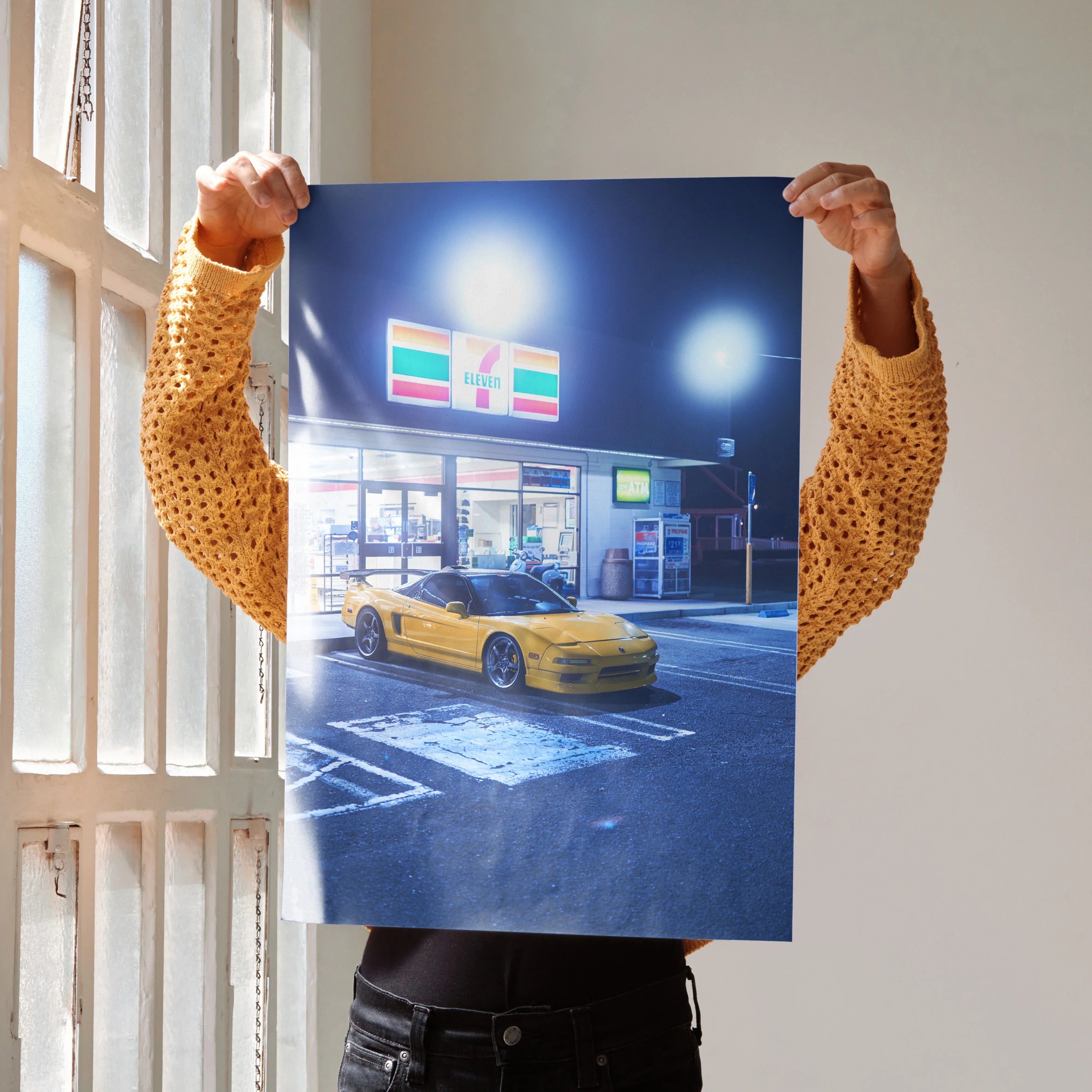 Acura NSX yellow sports car poster in urban night scene wall art with bright lights.