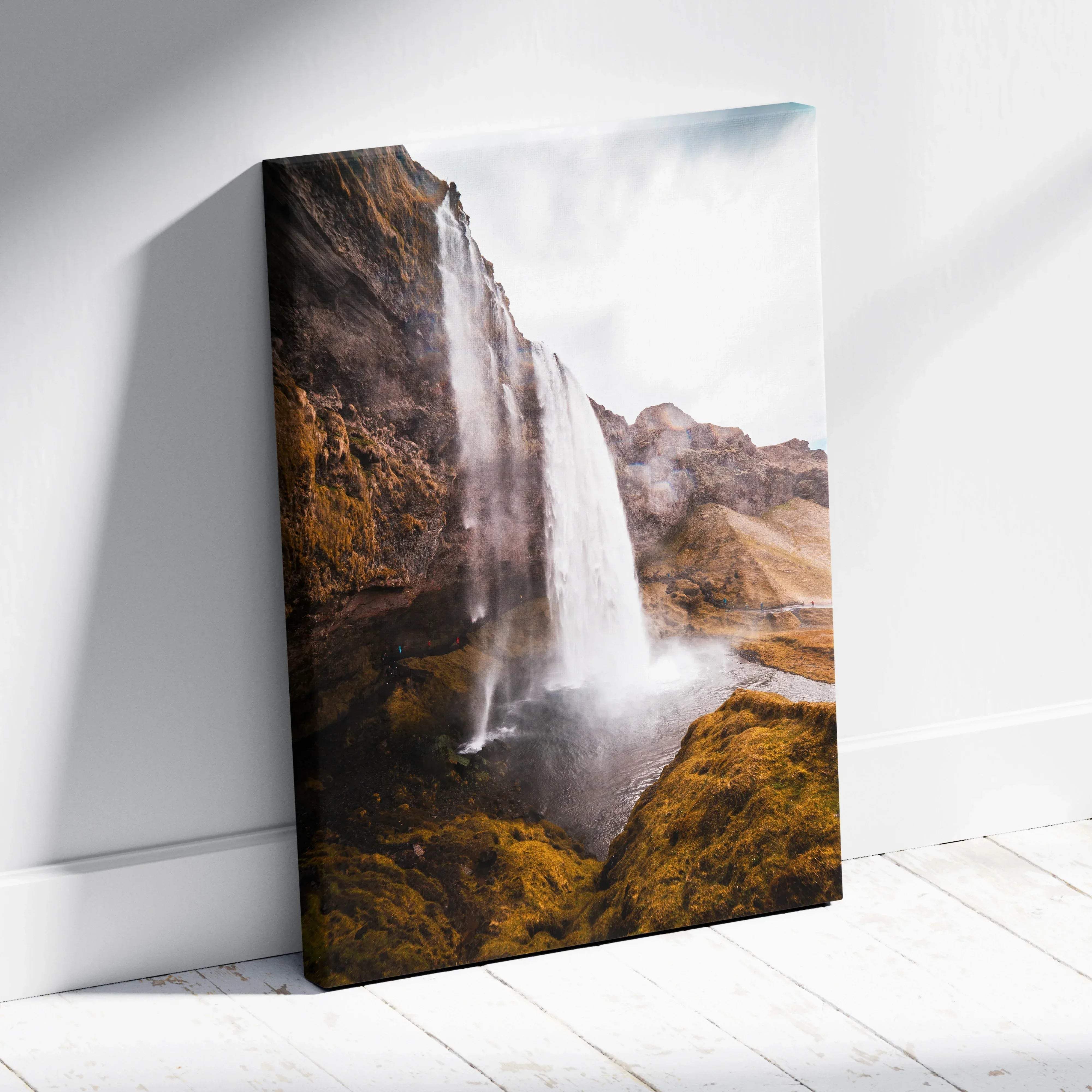 Iceland waterfall canvas wall art showing a dramatic waterfall on mossy cliffs under an overcast sky for home decor