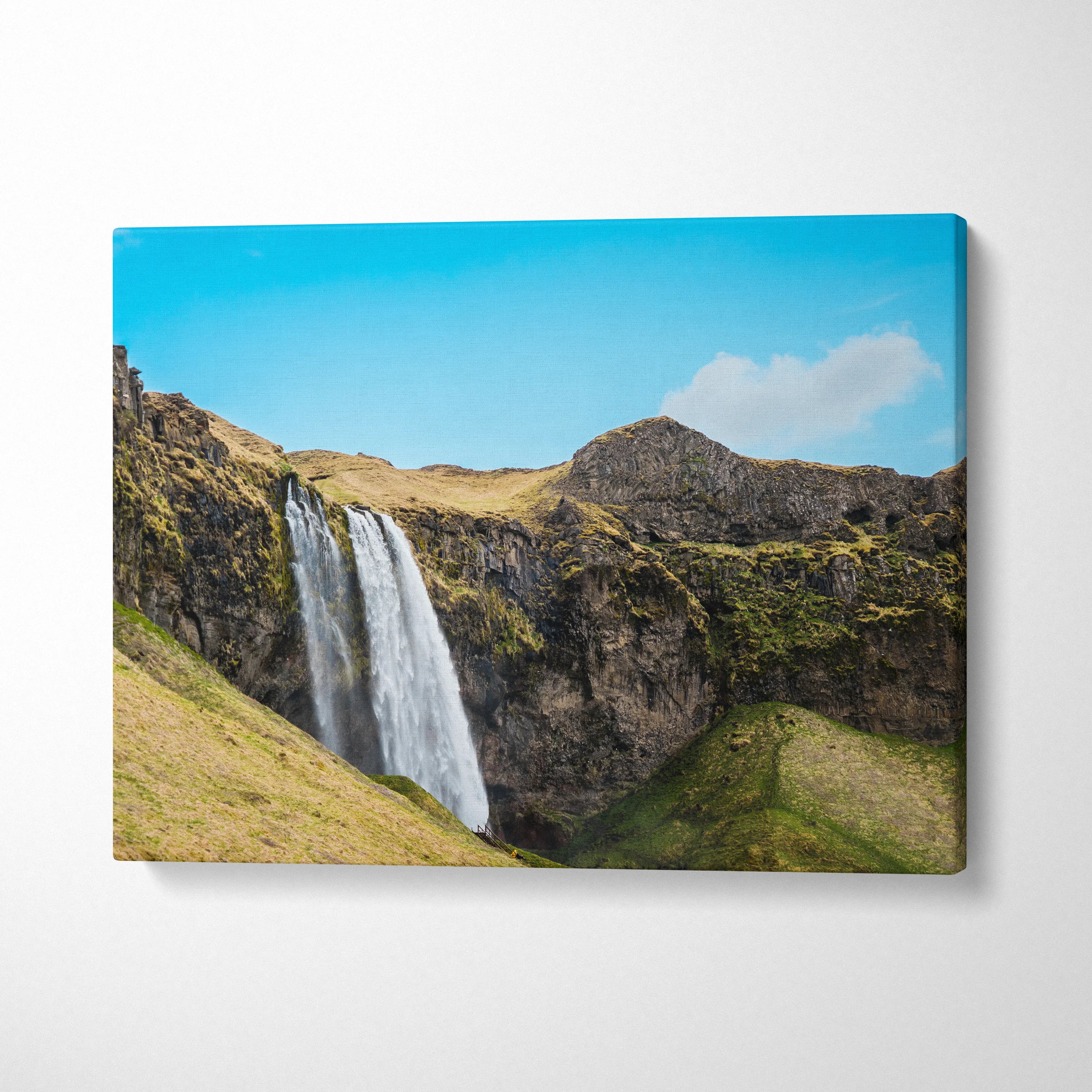 Icelandic waterfall nature landscape canvas wall art with blue sky and rocky cliffs decor.