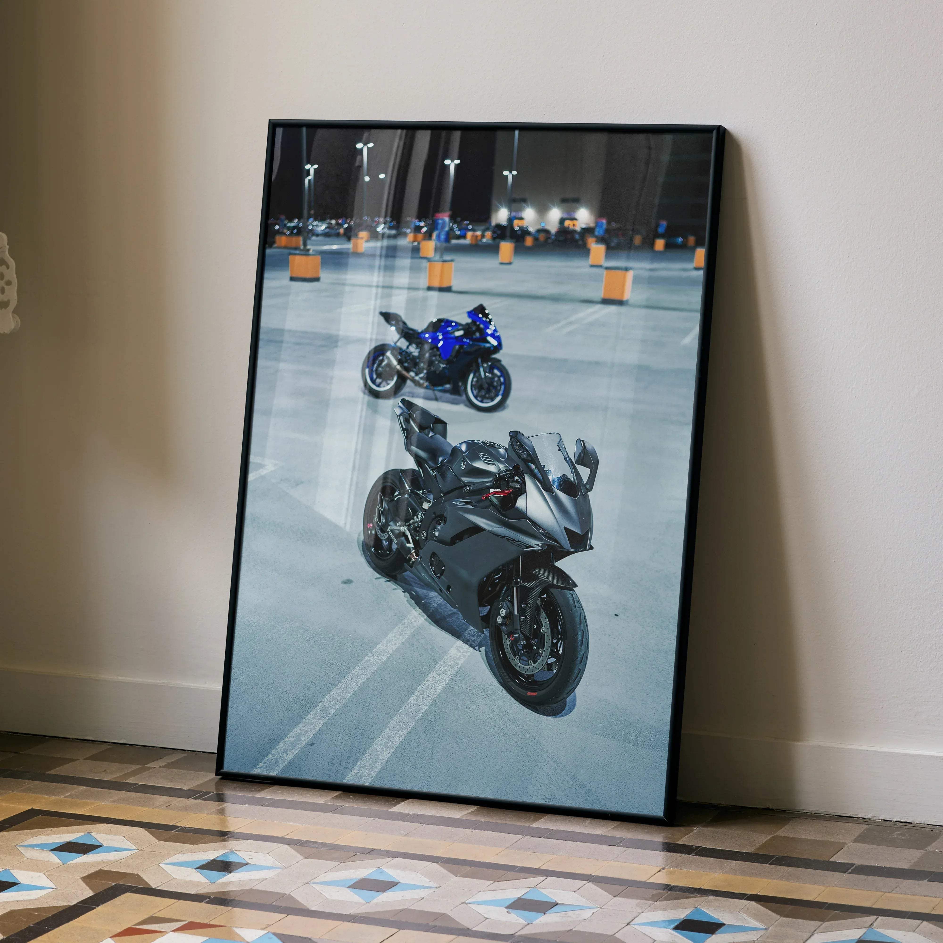 Black-framed canvas print of blue and dark gray Yamaha r1 and r6 sport motorcycles parked in a nighttime lot