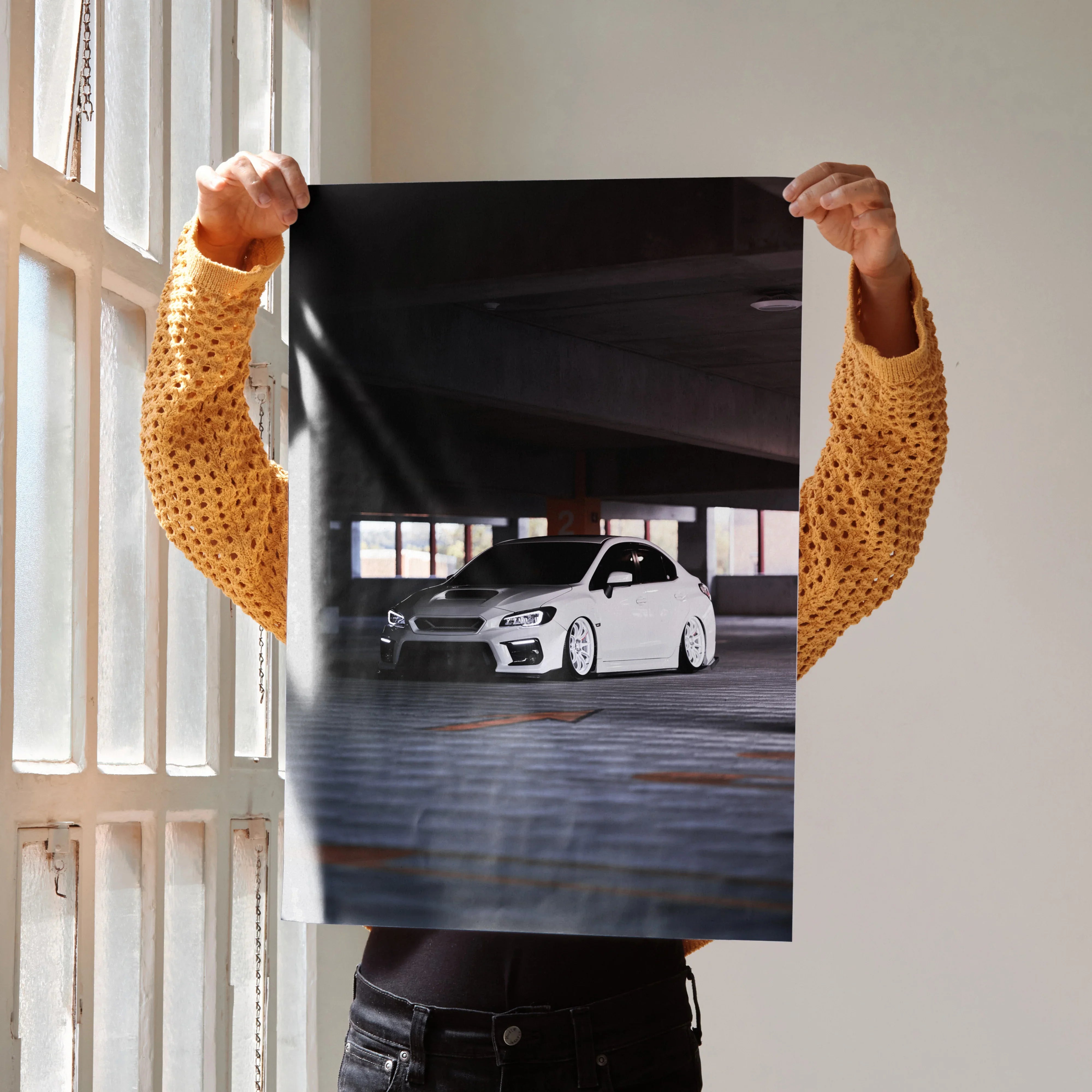 White Subaru WRX car poster displayed as sleek automotive wall art with dark indoor background.